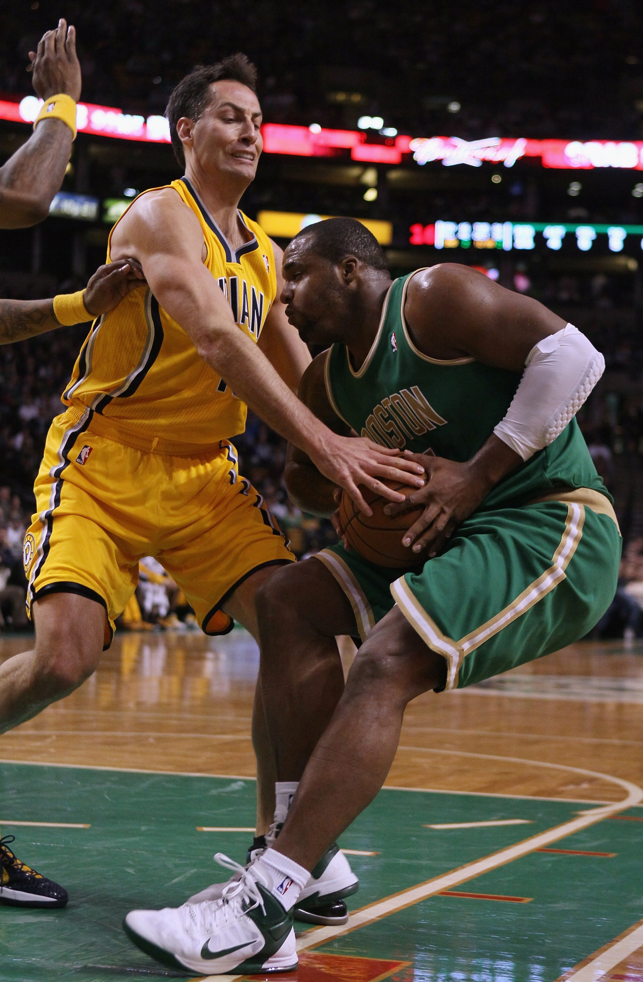 BOSTON, MA - MARCH 16:  Glen Davis #11 of the Boston Celtics tries to hang on to the ball as Jeff Foster #10 of the Indiana Pacers defends on March 16, 2011 at the TD Garden in Boston, Massachusetts.  NOTE TO USER: User expressly acknowledges and agrees t