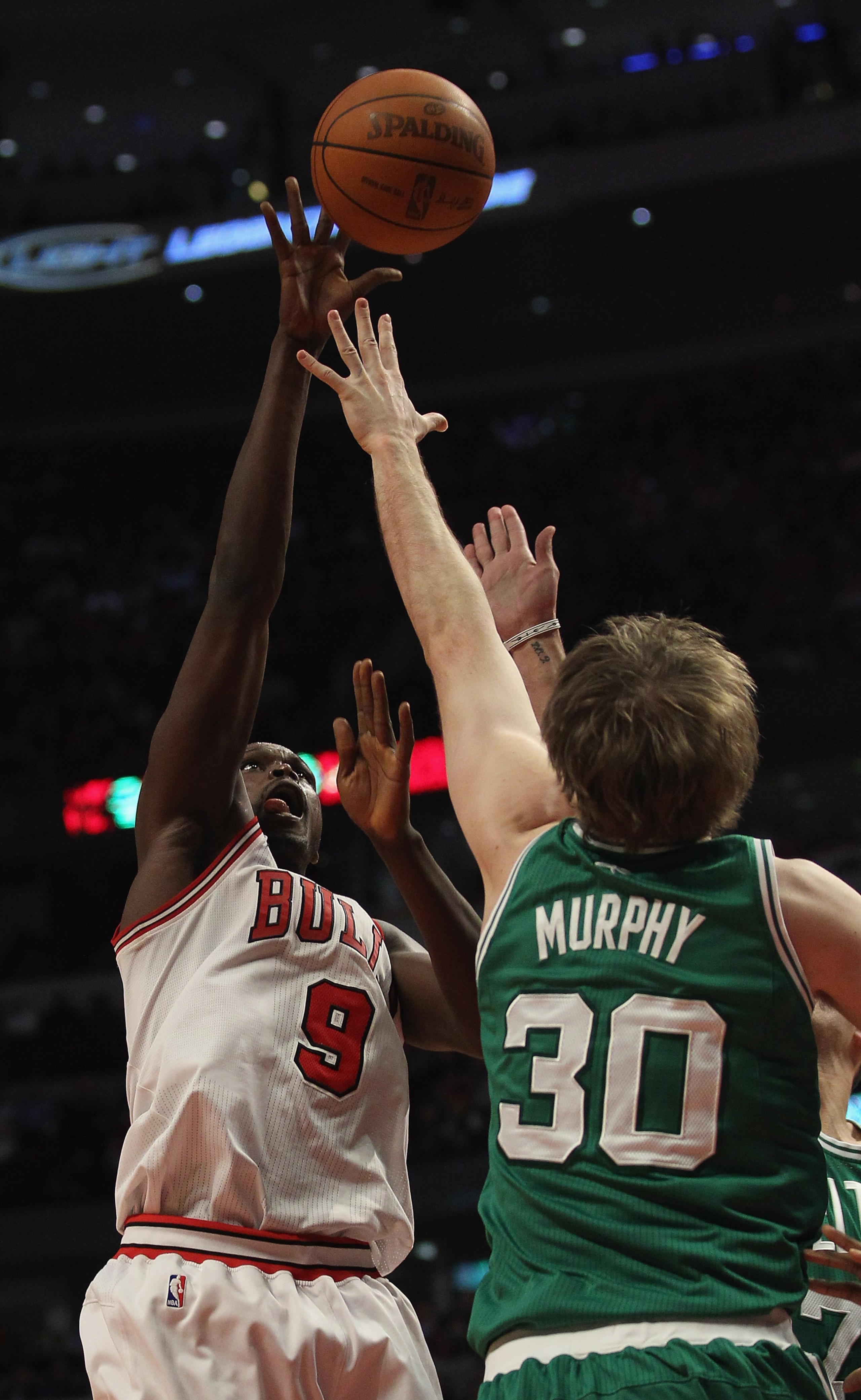 CHICAGO, IL - APRIL 07: Loul Deng #9 of the Chicago Bulls puts up a shot over Troy Murphy #30 of the Boston Celtics at United Center on April 7, 2011 in Chicago, Illinois. The Bulls defeated the Celtics 97-81. NOTE TO USER: User expressly acknowledges and