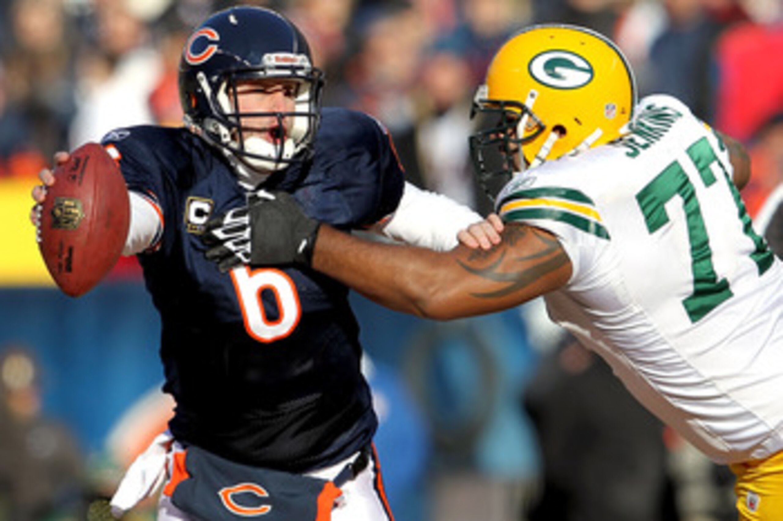 CHICAGO, IL - JANUARY 23:  Quarterback Jay Cutler #6 of the Chicago Bears attempts to avoid a sack by Cullen Jenkins #77 of the Green Bay Packers in the first quarter of the NFC Championship Game at Soldier Field on January 23, 2011 in Chicago, Illinois. 