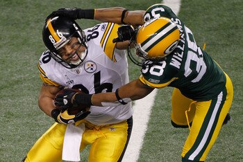 ARLINGTON, TX - FEBRUARY 06:  Hines Ward #86 of the Pittsburgh Steelers tries to avoid the tackle of Tramon Williams #38 of the Green Bay Packers during Super Bowl XLV at Cowboys Stadium on February 6, 2011 in Arlington, Texas.  (Photo by Joe Robbins/Gett