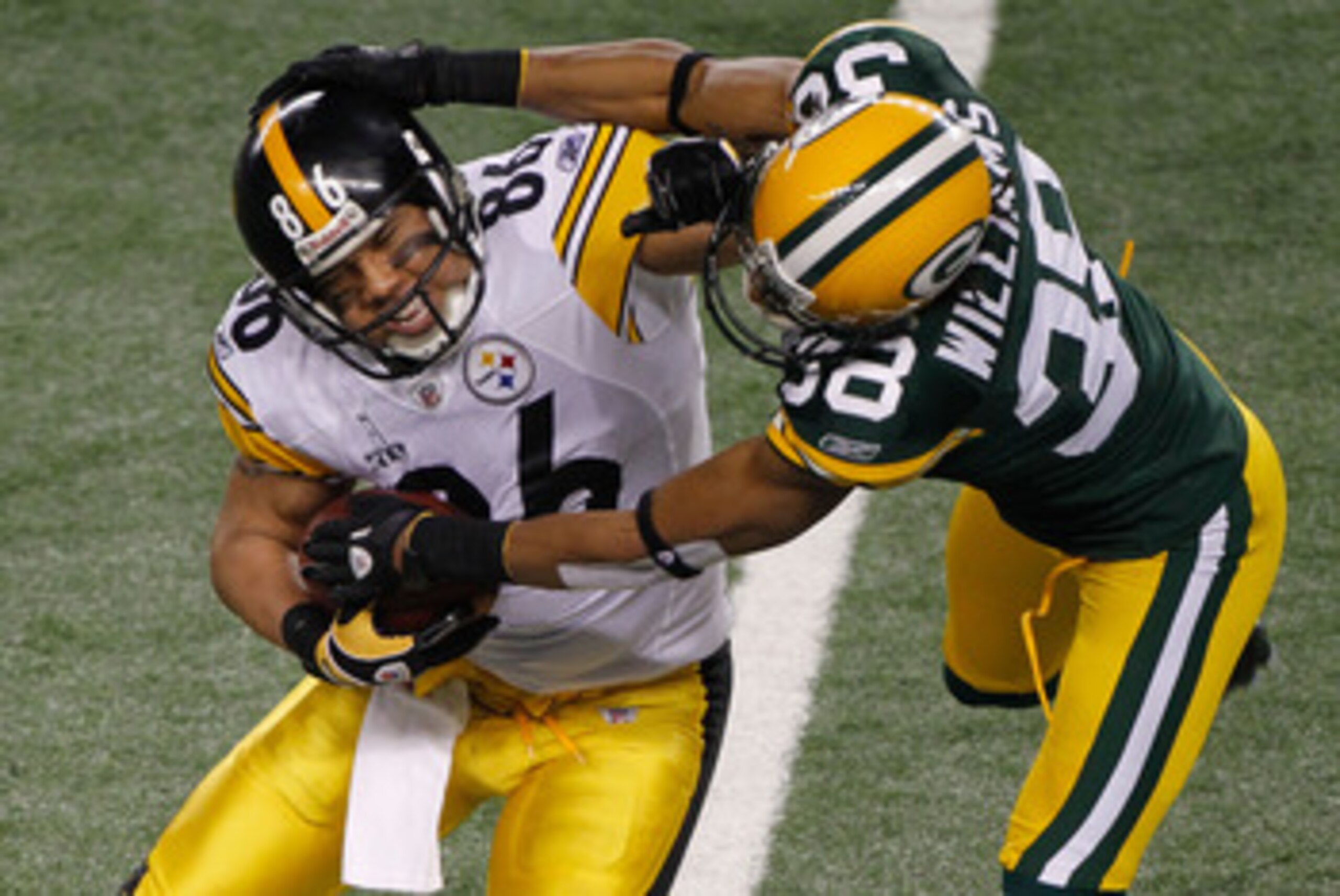 ARLINGTON, TX - FEBRUARY 06: Hines Ward #86 of the Pittsburgh Steelers tries to avoid the tackle of Tramon Williams #38 of the Green Bay Packers during Super Bowl XLV at Cowboys Stadium on February 6, 2011 in Arlington, Texas. (Photo by Joe Robbins/Gett ARLINGTON, TX - FEBRUARY 06: Hines Ward #86 of the Pittsburgh Steelers tries to avoid the tackle of Tramon Williams #38 of the Green Bay Packers during Super Bowl XLV at Cowboys Stadium on February 6, 2011 in Arlington, Texas. (Photo by Joe Robbins/Gett