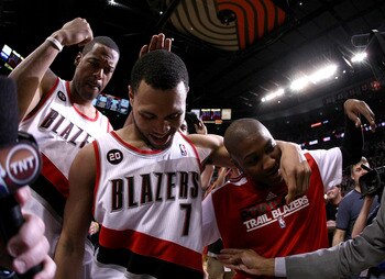 PORTLAND, OR - APRIL 23:  Brandon Roy #7 of the Portland Trail Blazers celebrates with teammates Marcus Camby #23 and Armon Johnson #1 after overcoming a 23 point deficit to defeat the of the Dallas Mavericks 84-82 in Game Four of the Western Conference Q