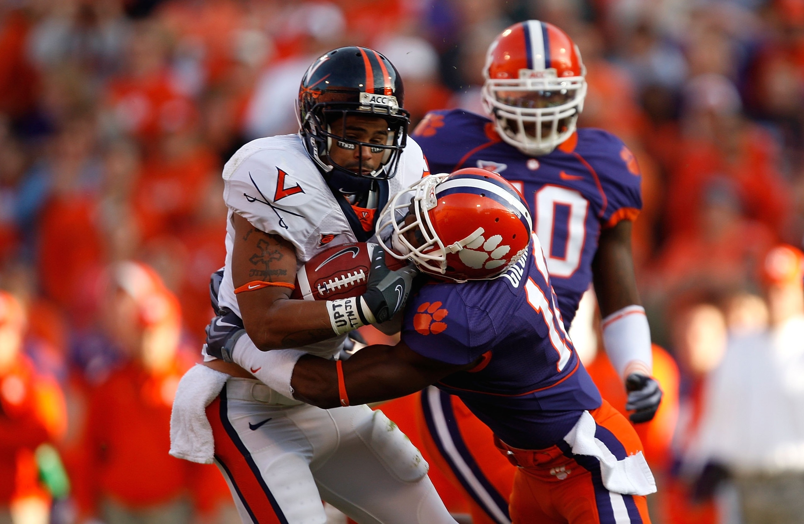 CLEMSON, SC - NOVEMBER 21:  Marcus Gilchrist #12 of the Clemson Tigers tackles Mikell Simpson #5 of the Virginia Cavaliers during the game at Memorial Stadium on November 21, 2009 in Clemson, South Carolina.  (Photo by Streeter Lecka/Getty Images)