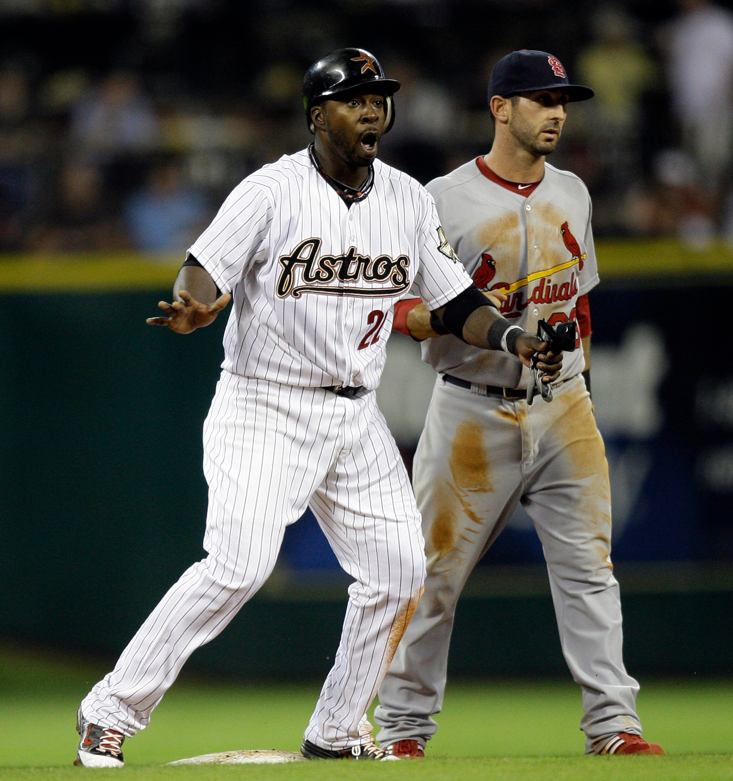 HOUSTON - APRIL 26:  Bill Hall #22 of the Houston Astros reacts after being caught in a run-down in the fourth inning against the St. Louis Cardinals as Daniel Descalso #33 of the St. Louis Cardinals looks on at Minute Maid Park on April 26, 2011 in Houst