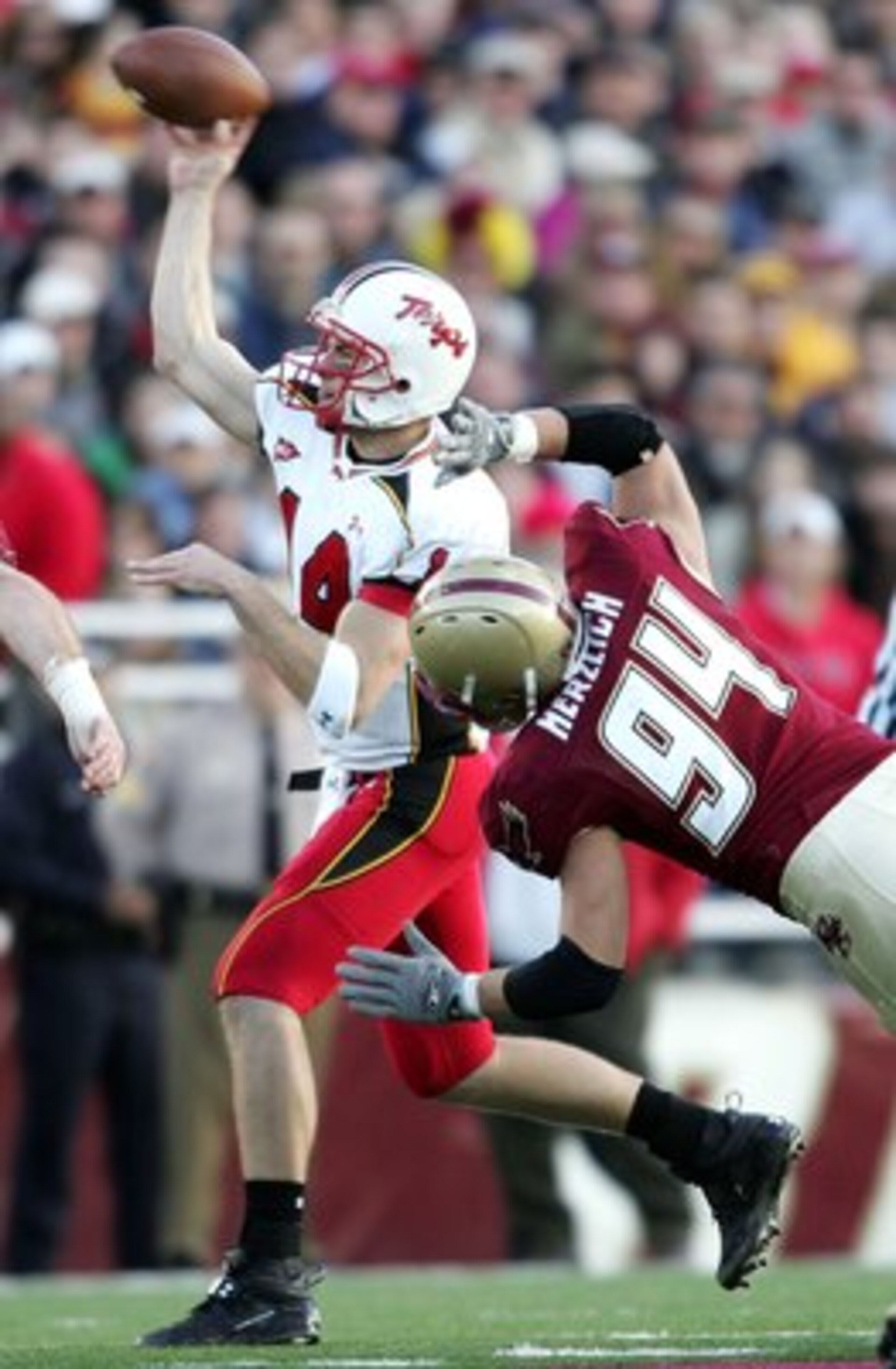 CHESTNUT HILL, MA - NOVEMBER 18:  Sam Hollenbach #14 of the Maryland Terrapins is pressured by Mark Herzlich #94 of the Boston College Eagles on November 18, 2006 at Alumni Stadium in Chestnut Hill, Massachusetts. Boston College defeated Maryland 38-16.  