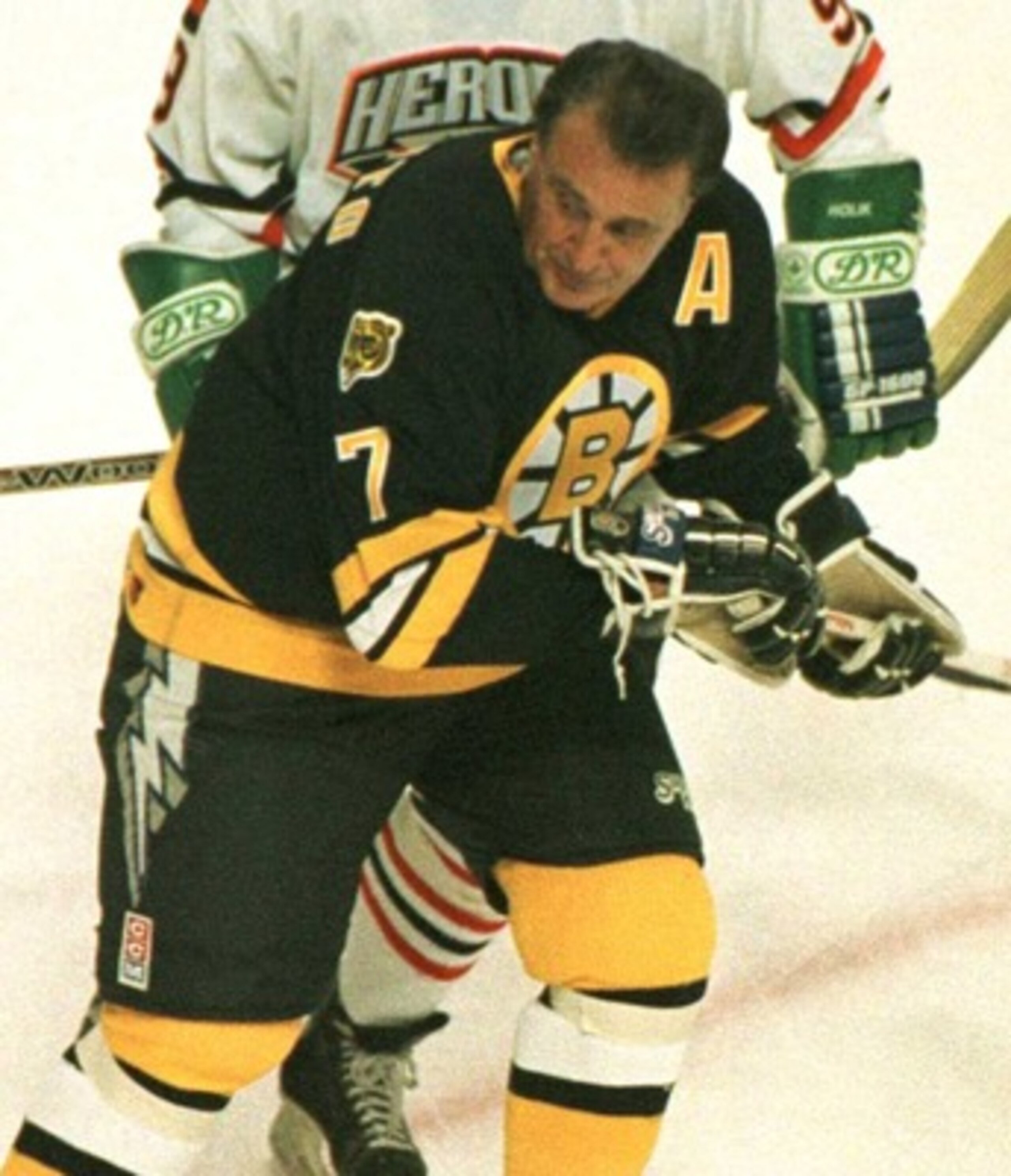 19 Jan 1996:  Wielding a double bladed stick, Gordie Howe #9 of the NHL Heroes checks Phil Esposito #7 of the Boston Bruins Heroes from behind during the second period of the NHL Heroes of Hockey game played at the Fleet Center in Boston, Massachusetts. M