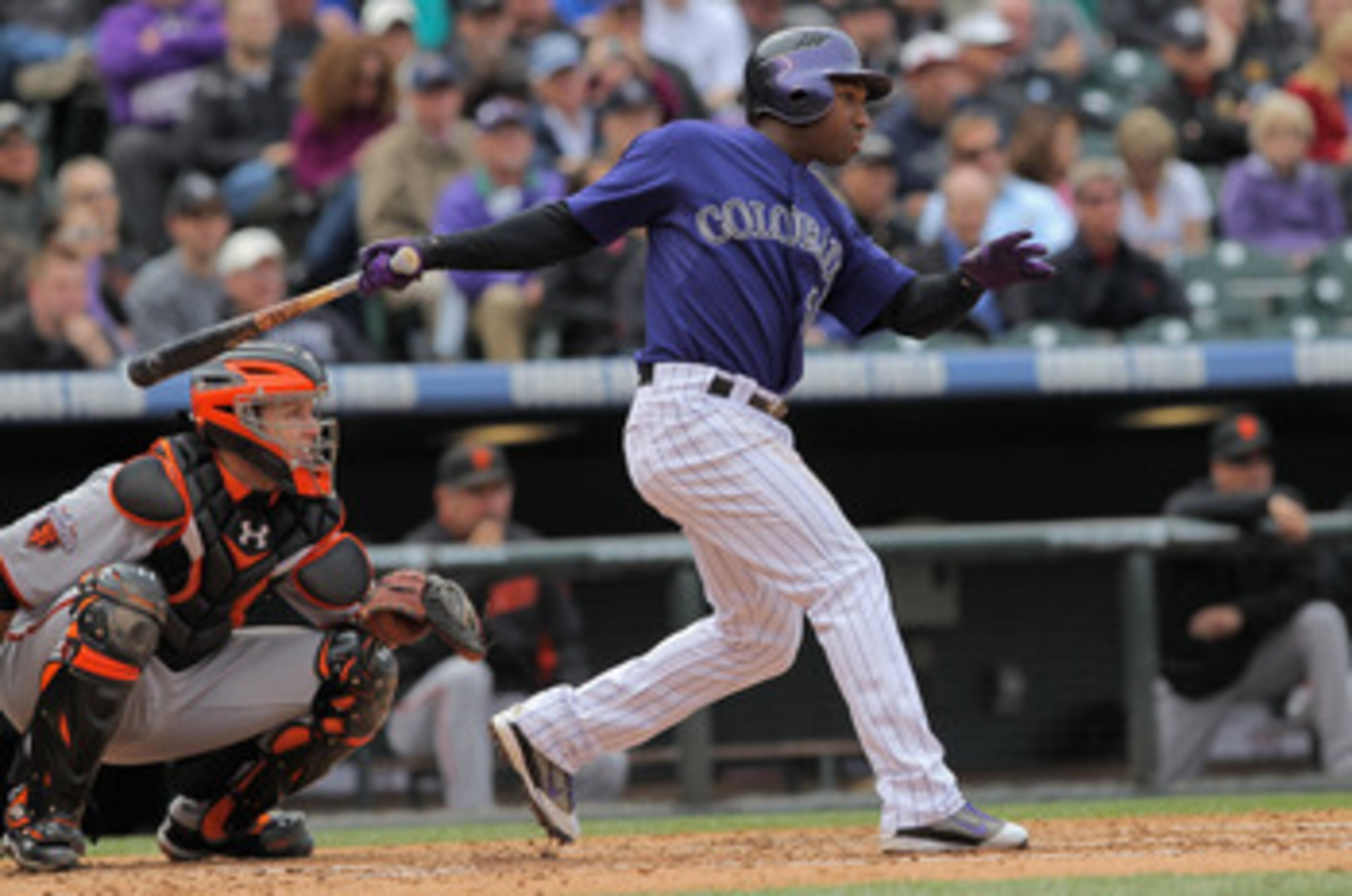 DENVER, CO - APRIL 20:  Jonathan Herrera #18 of the Colorado Rockies takes an at bat as catcher Buster Posey #28 of the San Francisco Giants backs up the plate at Coors Field on April 20, 2011 in Denver, Colorado.  (Photo by Doug Pensinger/Getty Images)