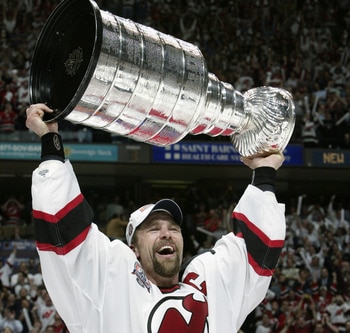 EAST RUTHERFORD, NJ - JUNE 9:  Scott Stevens #4 of the New Jersey Devils holds up the Stanley Cup after defeating the Mighty Ducks of Anaheim 3-0 in game seven of the 2003 Stanley Cup Finals at Continental Airlines Arena on June 9, 2003 in East Rutherford