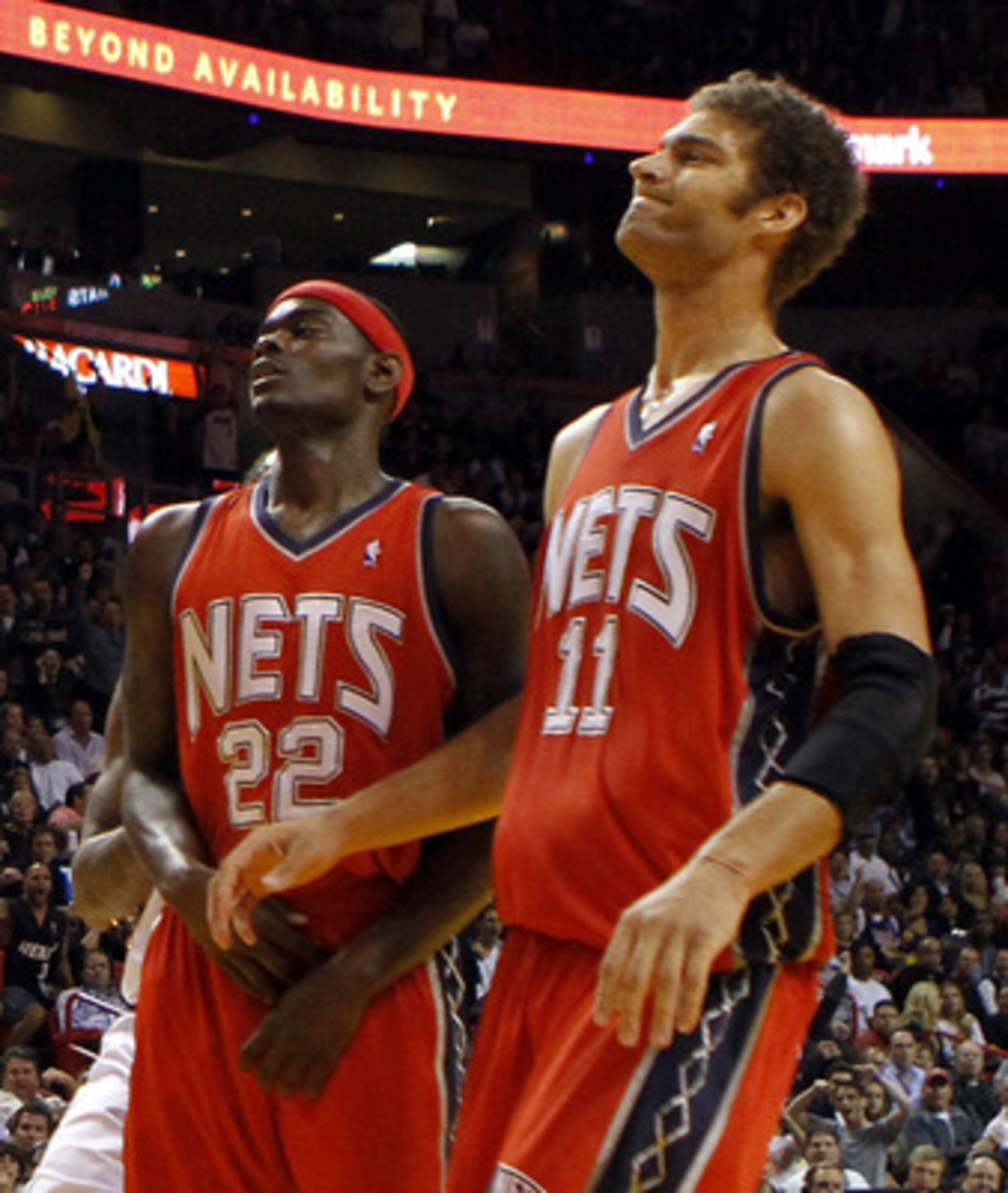 MIAMI - NOVEMBER 06:  Guard Dwyane Wade #3 of the Miami Heat dunks against forward guard Anthony Morrow #22 and center Brook Lopez #11  of the New Jersey Nets  at American Airlines Arena on November 6, 2010 in Miami, Florida. NOTE TO USER: User expressly