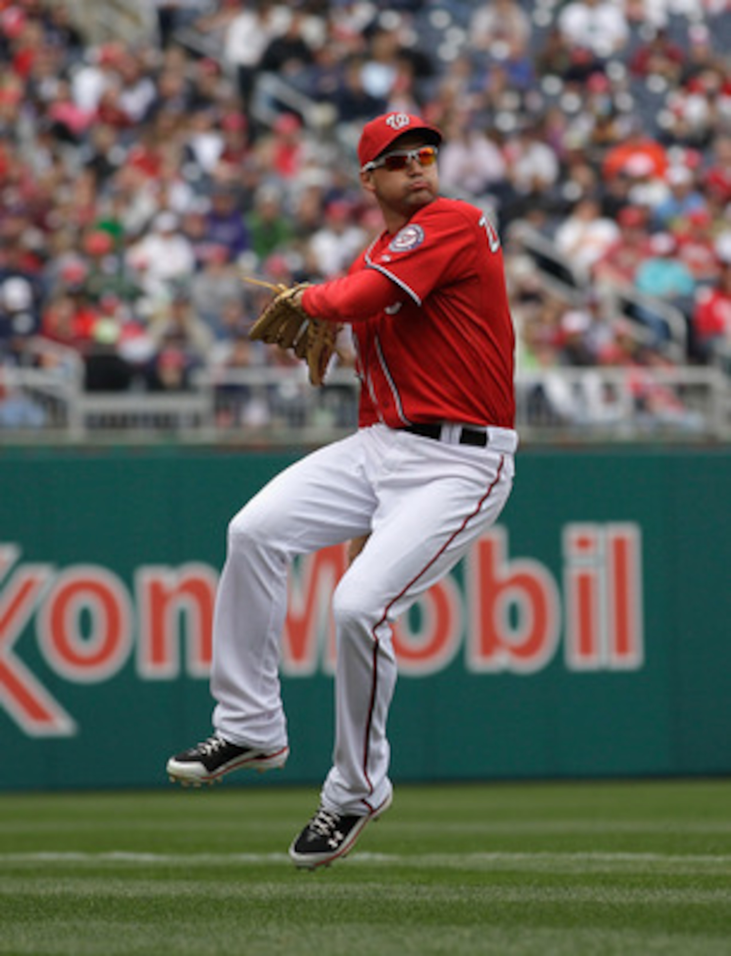 WASHINGTON, DC - APRIL 03:  Third baseman Ryan Zimmerman #11 of the Washington Nationals makes a play against the Atlanta Braves at Nationals Park on April 3, 2011 in Washington, DC.  (Photo by Rob Carr/Getty Images)