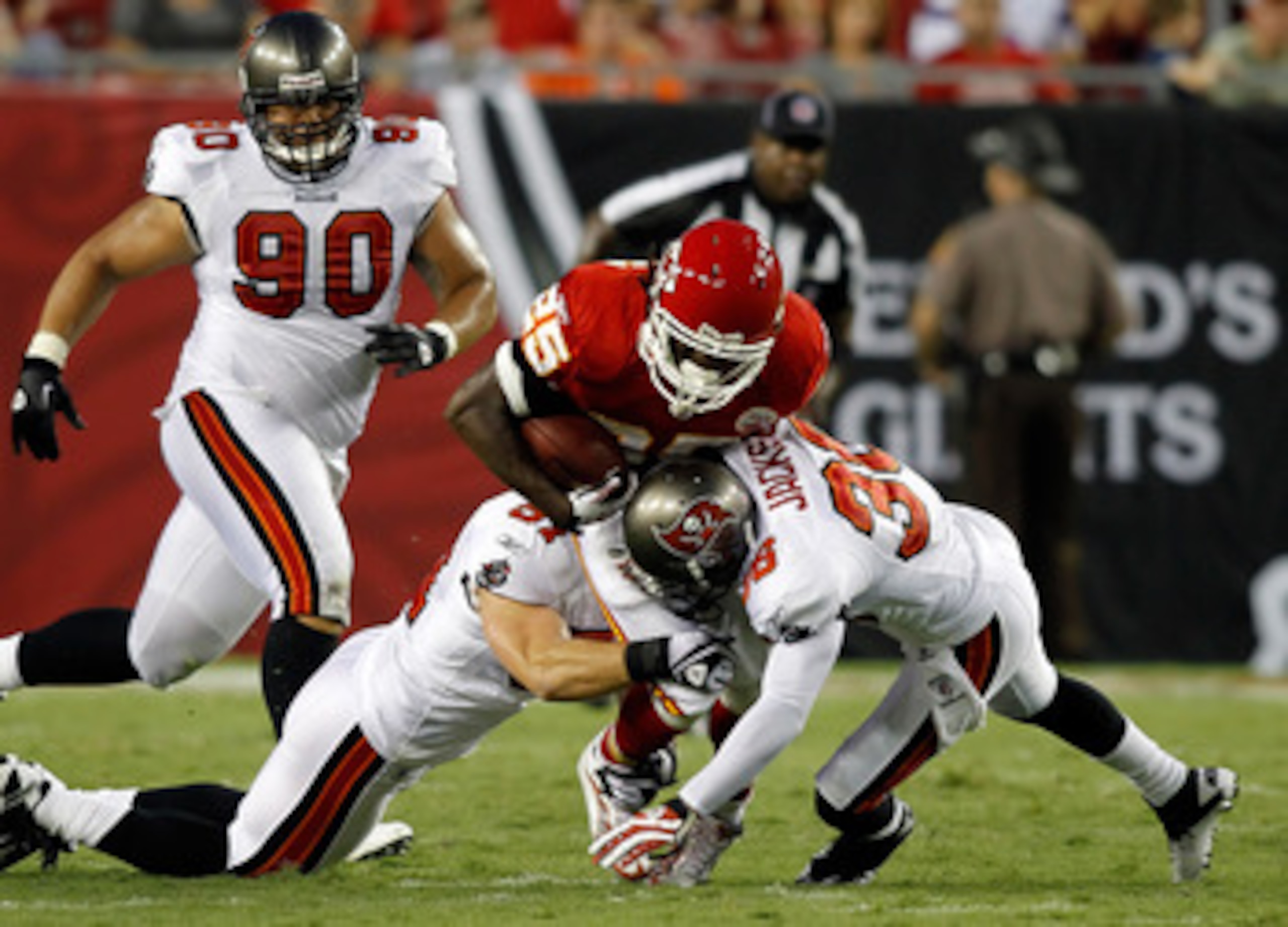 TAMPA, FL - AUGUST 21:  Defenders Barrett Ruud #51 and Tanard Jackson #36 of the Tampa Bay Buccaneers tackle running back Jamaal Charles #25 of the Kansas City Chiefs during a preseason game at Raymond James Stadium on August 21, 2010 in Tampa, Florida.  