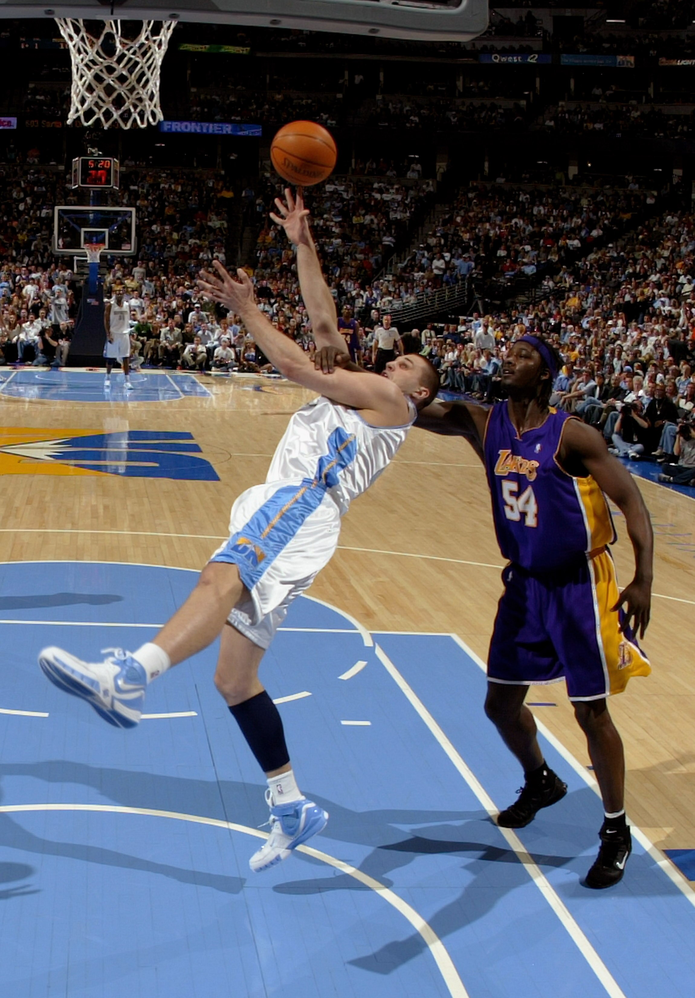 DENVER - MARCH 15:  Linas Kleiza #43 of the Denver Nuggets is fouled by Kwame Brown #54 of the Los Angeles as the Nuggets defeated the Lakers 113-86 during NBA action at the Pepsi Center on March 15, 2007 in Denver, Colorado. NOTE TO USER: User expressly
