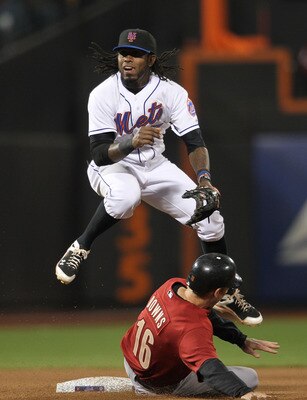 NEW YORK, NY - APRIL 21: Jose Reyes #7 of the New York Mets turns a double play over the slide of Matt Downs #16 of the Houston Astros at Citi Field on April 21, 2011 in the Flushing neighborhood of the Queens borough of New York City.  (Photo by Nick Lah