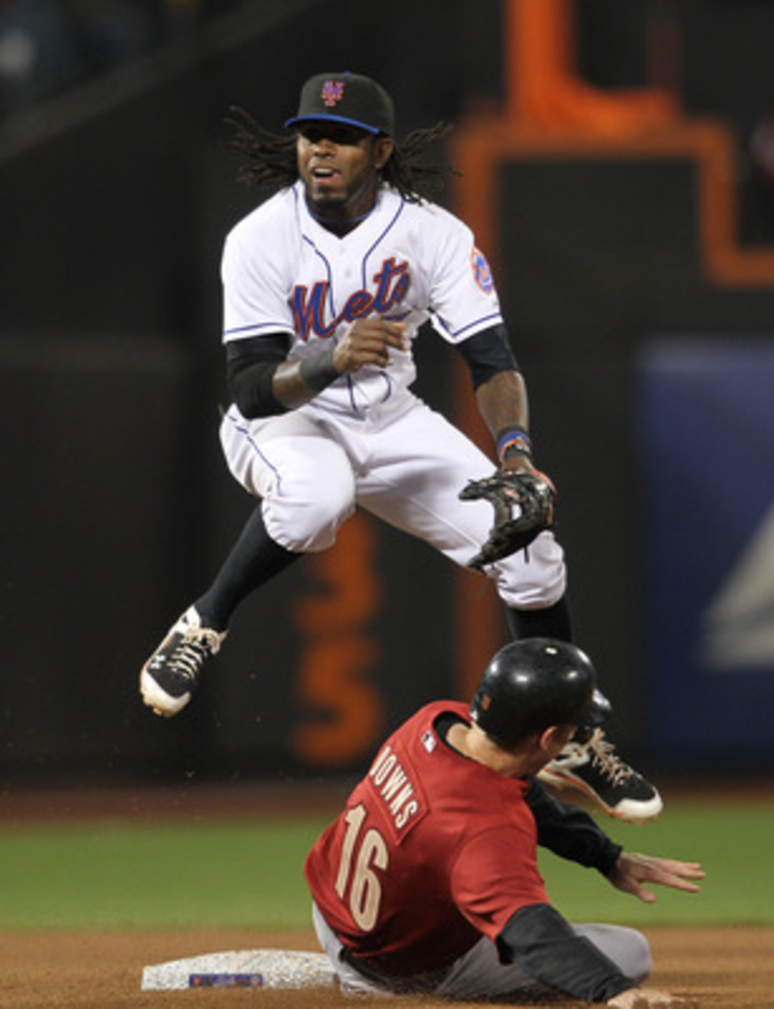 NEW YORK, NY - APRIL 21: Jose Reyes #7 of the New York Mets turns a double play over the slide of Matt Downs #16 of the Houston Astros at Citi Field on April 21, 2011 in the Flushing neighborhood of the Queens borough of New York City.  (Photo by Nick Lah