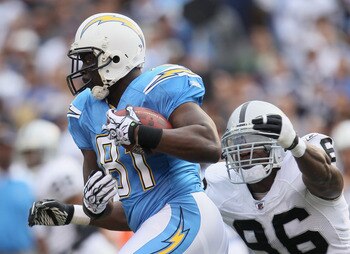 SAN DIEGO - DECEMBER 05:  Randy McMichael #81 of the San Diego Chargers is pursued by Kamerion Wimbley #96 of the Oakland Raiders at Qualcomm Stadium on December 5, 2010 in San Diego, California. The Raiders defeated the Chargers 28-13.  (Photo by Jeff Gr