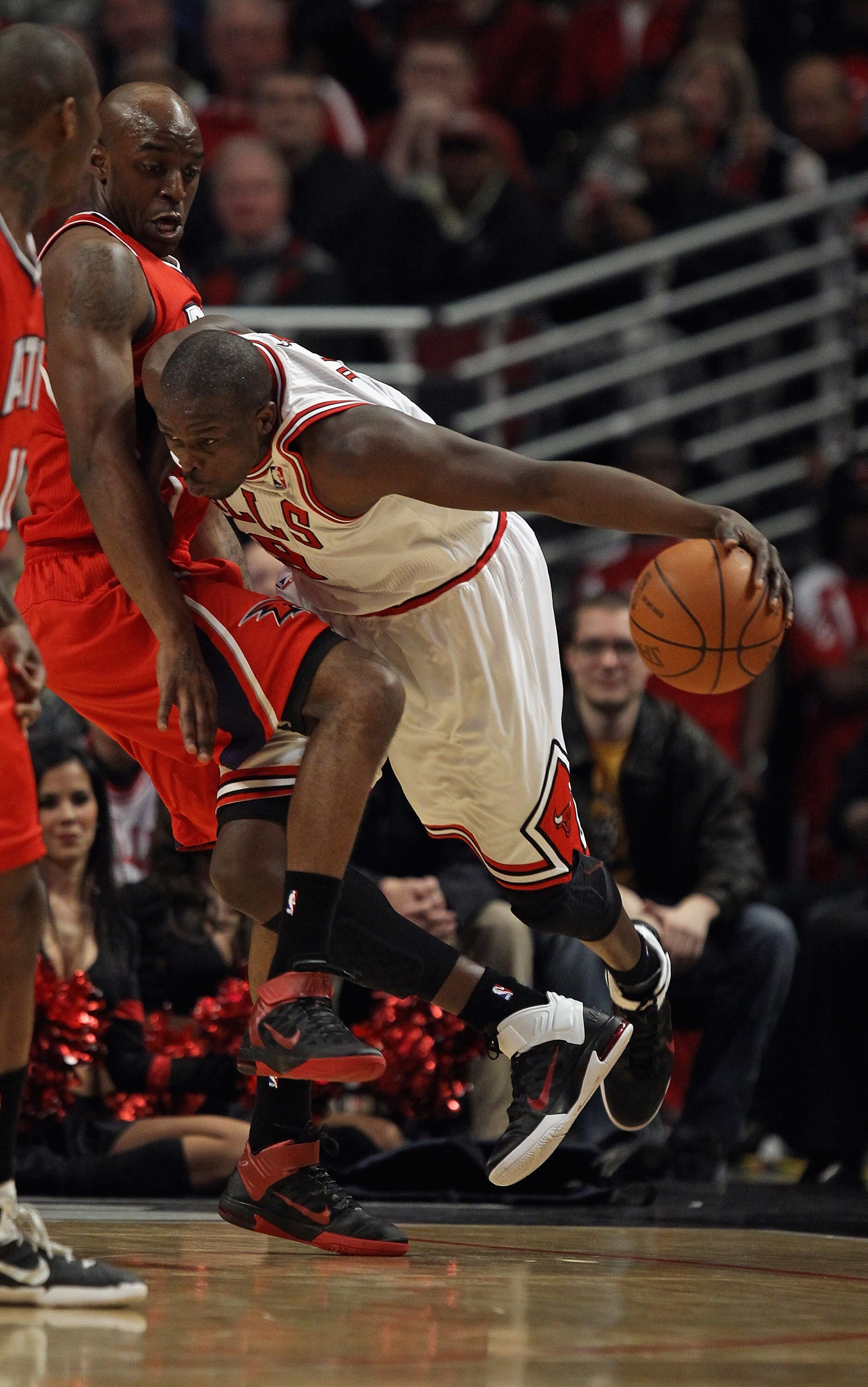 CHICAGO, IL - MAY 02: Loul Deng #9 of the Chicago Bulls is fouled by Damien Wilkins #3 of the Atlanta Hawks in Game One of the Eastern Conference Semifinals in the 2011 NBA Playoffs at the United Center on May 2, 2011 in Chicago, Illinois. NOTE TO USER: U
