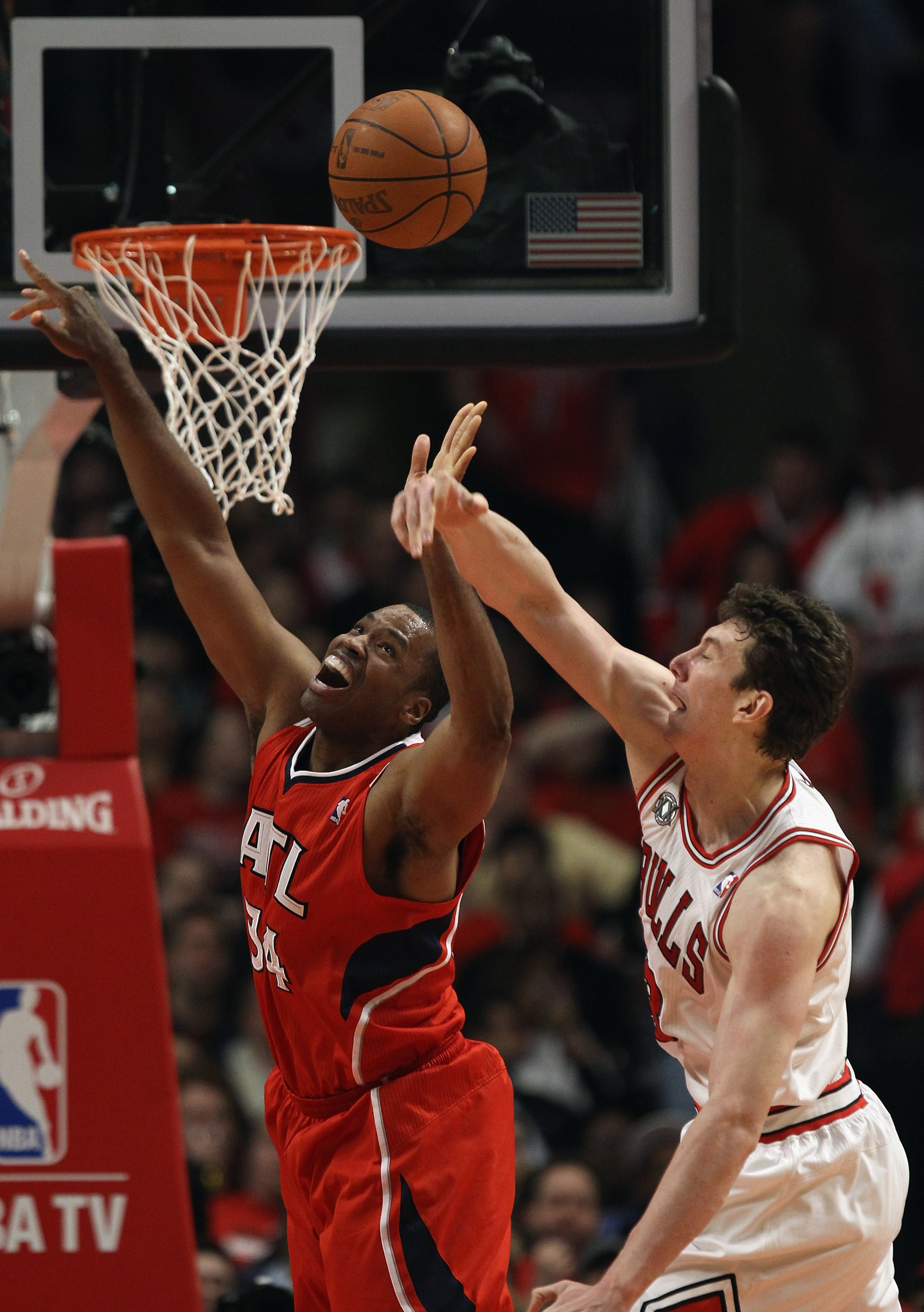 CHICAGO, IL - MAY 02: Jason Collins #34 of the Atlanta Hawks battles for a rebound with Omer Asik #3 of the Chicago Bulls in Game One of the Eastern Conference Semifinals in the 2011 NBA Playoffs at the United Center on May 2, 2011 in Chicago, Illinois. N