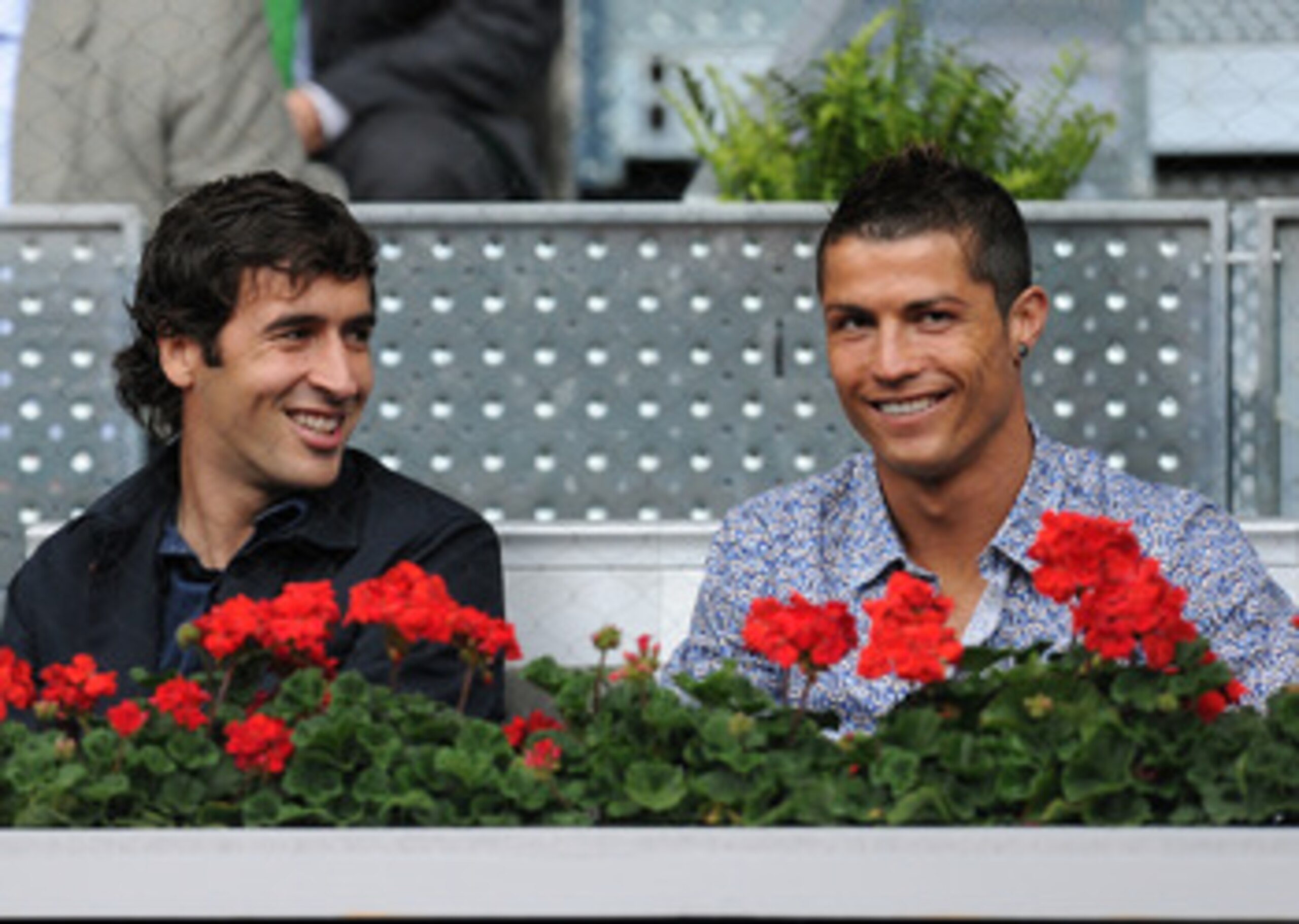 MADRID, SPAIN - MAY 12:  Cristiano Ronaldo (R) and Raul Gonzalez of Real Madrid smile during the second round match between Rafael Nadal of Spain and Oleksandr Dolgopolov of Ukraine at the Mutua Madrilena Madrid Open tennis tournament at the Caja Magica o