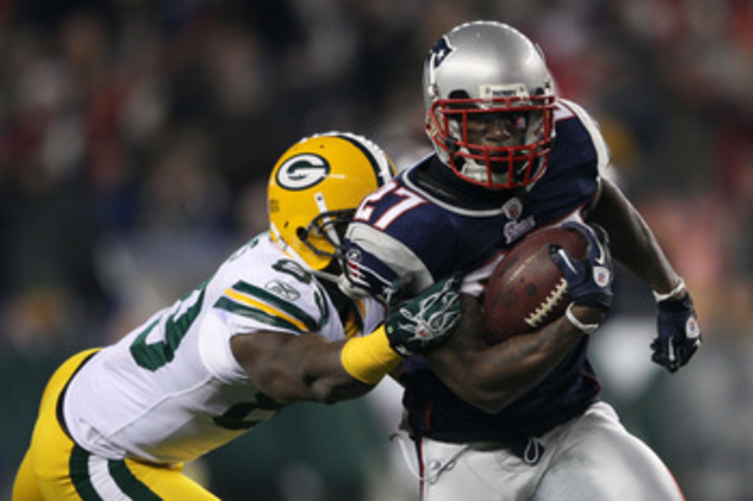 FOXBORO, MA - DECEMBER 19: Cornerback Kyle Arrington #27 of the New England Patriots evades wide receiver James Jones #89 of the Green Bay Packers to run the ball 36 yards and score a touchdown during the third quarter of the game at Gillette Stadium on FOXBORO, MA - DECEMBER 19: Cornerback Kyle Arrington #27 of the New England Patriots evades wide receiver James Jones #89 of the Green Bay Packers to run the ball 36 yards and score a touchdown during the third quarter of the game at Gillette Stadium on
