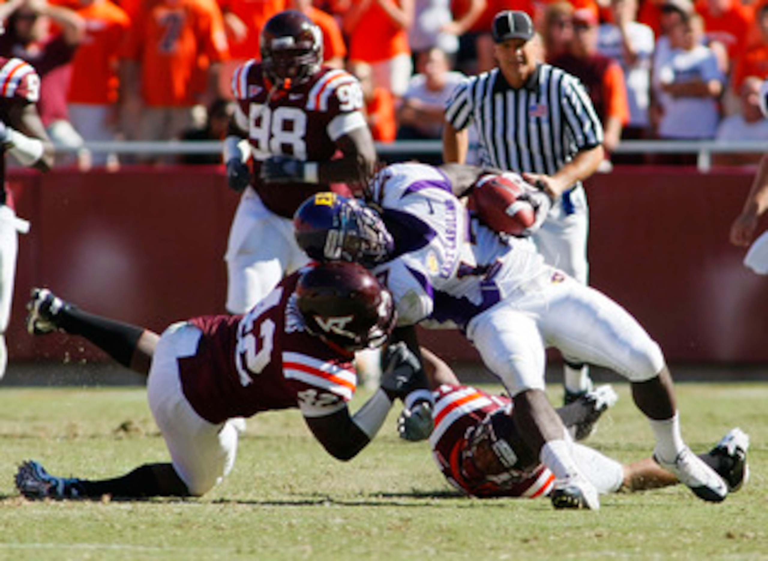 BLACKSBURG, VA - SEPTEMBER 18:  Defensive end J.R. Collins #42 and  cornerback Kyle Fuller #17 of the Virginia Tech Hokies tackle wide receiver Dwayne Harris #17 of the East Carolina Pirates at Lane Stadium on September 18, 2010 in Blacksburg, Virginia.