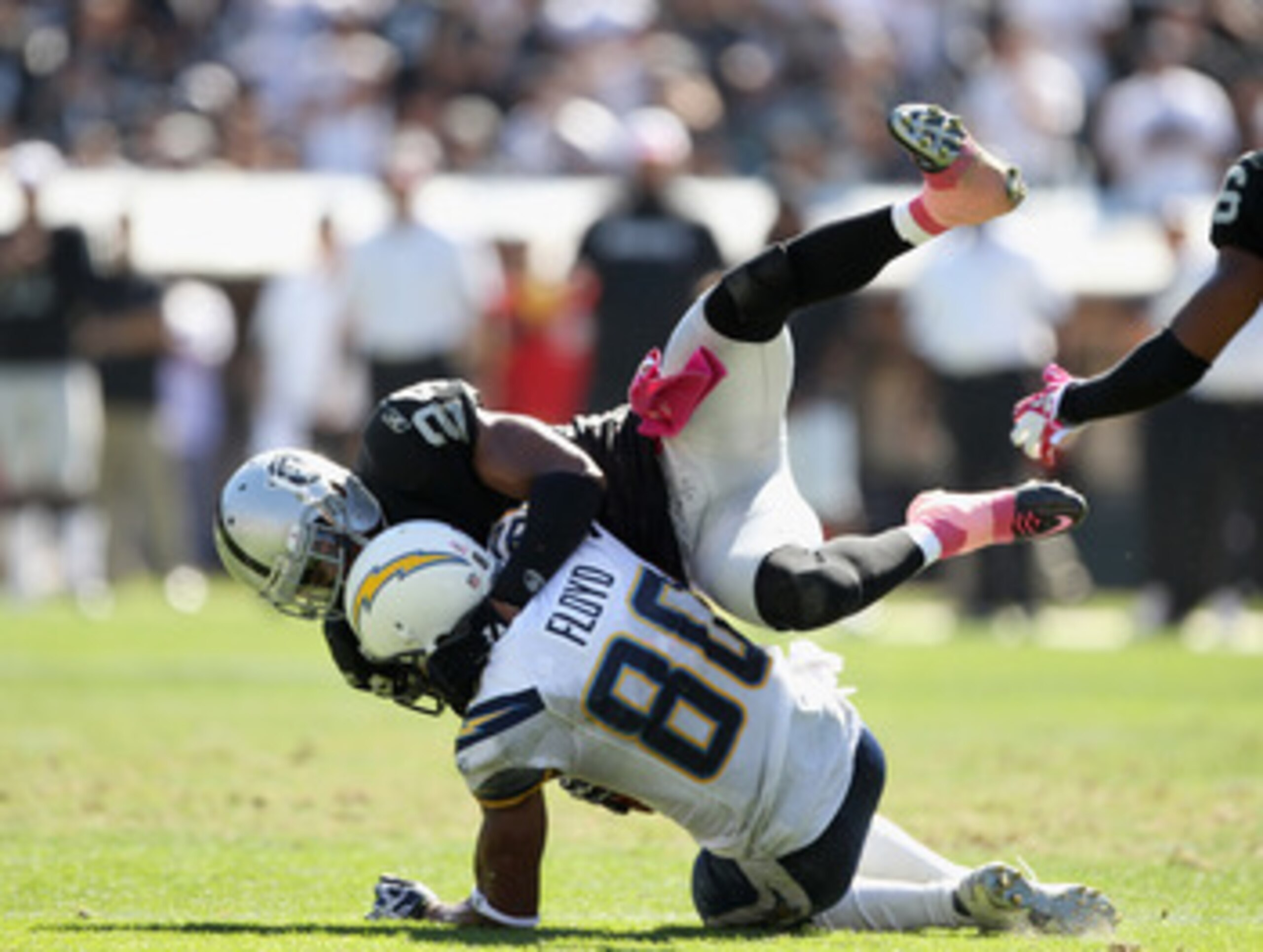 OAKLAND, CA - OCTOBER 10:  Malcom Floyd #80 of the San Diego Chargers is tackled by Michael Huff #24 of the Oakland Raiders at Oakland-Alameda County Coliseum on October 10, 2010 in Oakland, California.  (Photo by Ezra Shaw/Getty Images)
