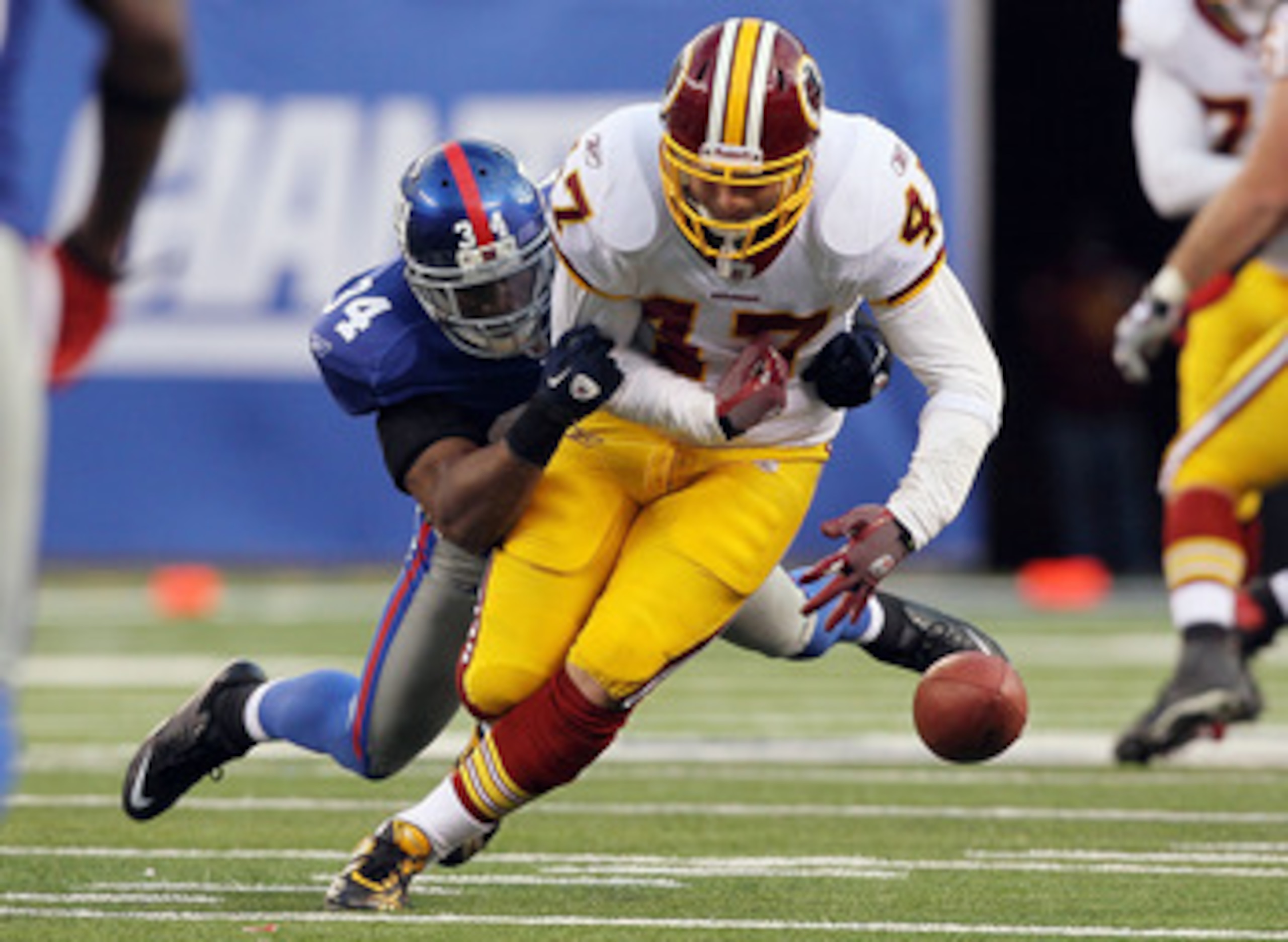 EAST RUTHERFORD, NJ - DECEMBER 05: Deon Grant #34 of the New York Giants forces a fourth quarter fumble against Chris Cooley #47 of the Washington Redskins on December 5, 2010 at the New Meadowlands Stadium in East Rutherford, New Jersey. The Giants defe EAST RUTHERFORD, NJ - DECEMBER 05: Deon Grant #34 of the New York Giants forces a fourth quarter fumble against Chris Cooley #47 of the Washington Redskins on December 5, 2010 at the New Meadowlands Stadium in East Rutherford, New Jersey. The Giants defe