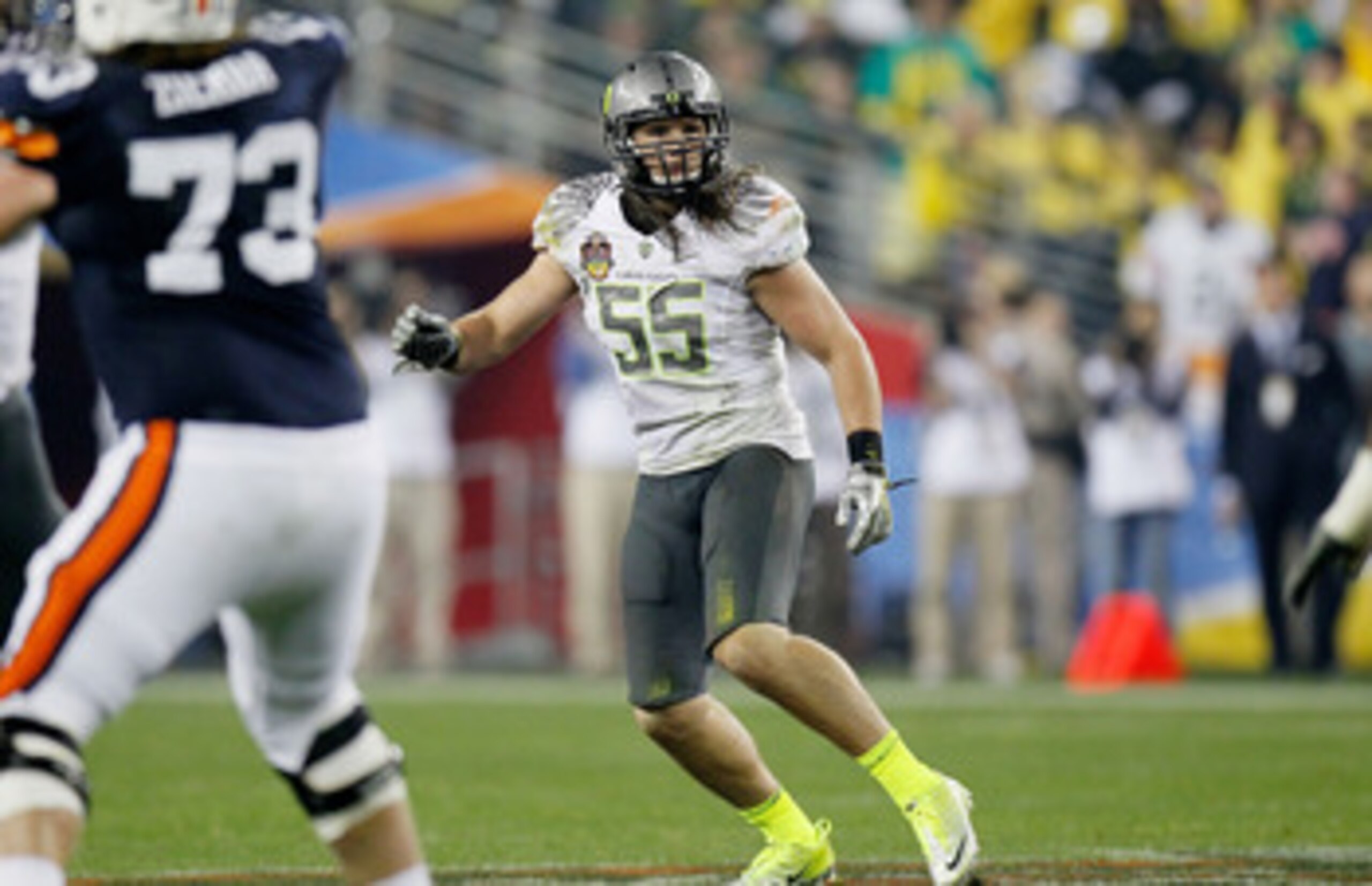 GLENDALE, AZ - JANUARY 10:  Casey Matthews #55 of the Oregon Ducks watches the play against the Auburn Tigers during the Tostitos BCS National Championship Game at University of Phoenix Stadium on January 10, 2011 in Glendale, Arizona.  (Photo by Kevin C.