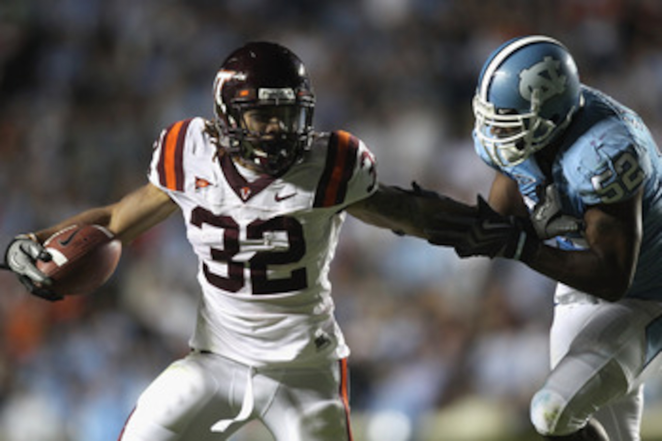 CHAPEL HILL, NC - NOVEMBER 13:  Darren Evans #32 of the Virginia Tech Hokies is tackled by Quan Sturdivant #52 of the North Carolina Tar Heels during their game at Kenan Stadium on November 13, 2010 in Chapel Hill, North Carolina.  (Photo by Streeter Leck