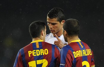 BARCELONA, SPAIN - MAY 03:  Cristiano Ronaldo of Real Madrid (C) argues with Pedro Rodriguez (L) and Dani Alves of FC Barcelona during the UEFA Champions League Semi Final second leg match between Barcelona and Real Madrid at the Camp Nou on May 3, 2011 i