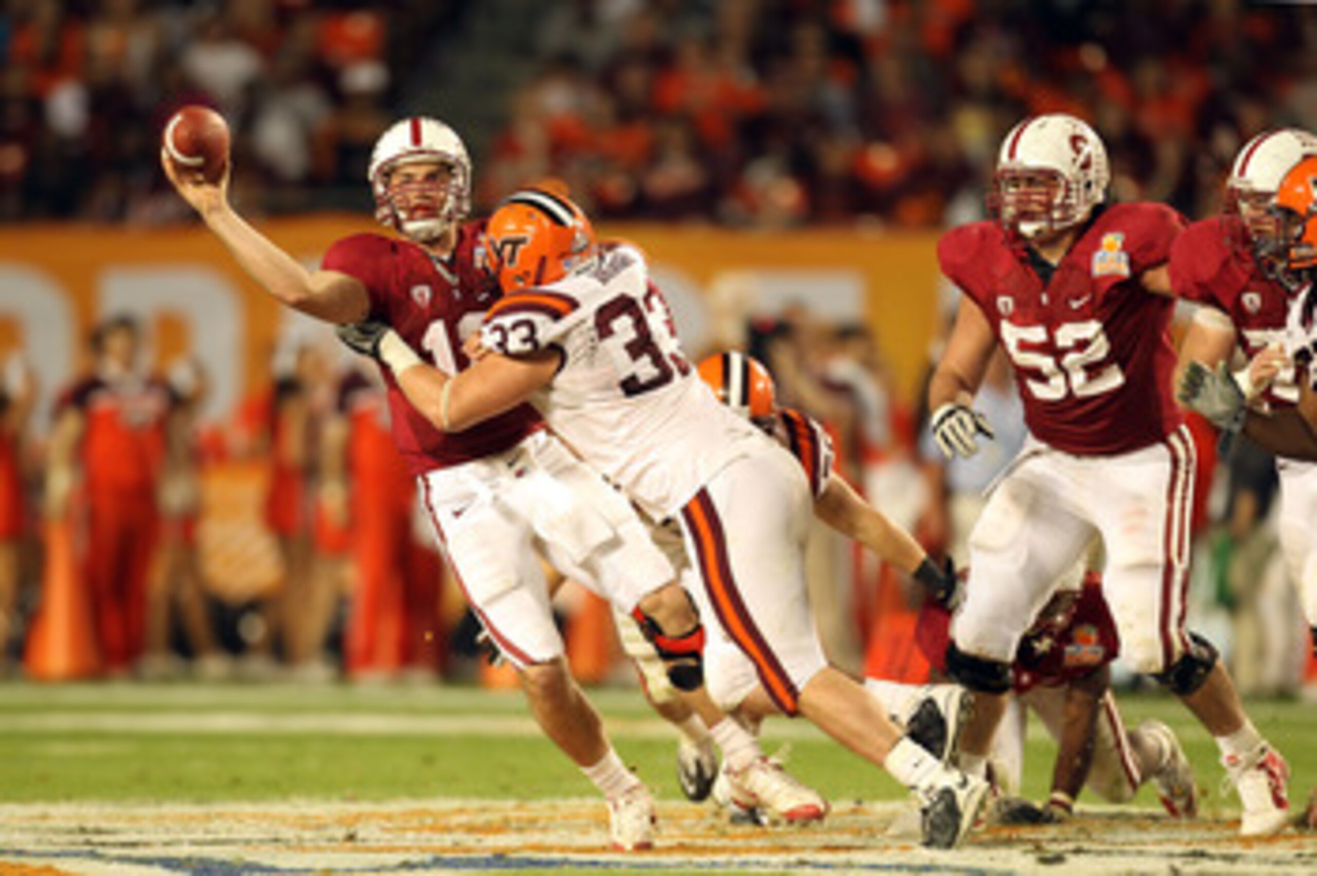 MIAMI, FL - JANUARY 03:  Andrew Luck #12 of the Stanford Cardinal throws a pass under pressure from Chris Drager #33 of the Virginia Tech Hokies during the 2011 Discover Orange Bowl at Sun Life Stadium on January 3, 2011 in Miami, Florida. Stanford won 40