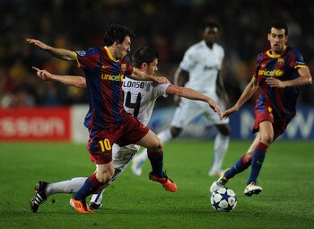 BARCELONA, SPAIN - MAY 03:  Lionel Messi (L) of Barcelona duels for the ball with Xabi Alonso of Real Madrid during the UEFA Champions League Semi Final second leg match between Barcelona and Real Madrid at the Camp Nou stadium on May 3, 2011 in Barcelona