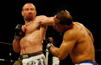 EAST RUTHERFORD, NJ - APRIL 04:  Vladimir Matyushenko in the green and white trunks of Midwest Combat lands a left hook on Jamal Patterson of the Renzo Gracie Jiu-Jitsu in the International Fighting League match at the Izod Center on April 4, 2008 in East