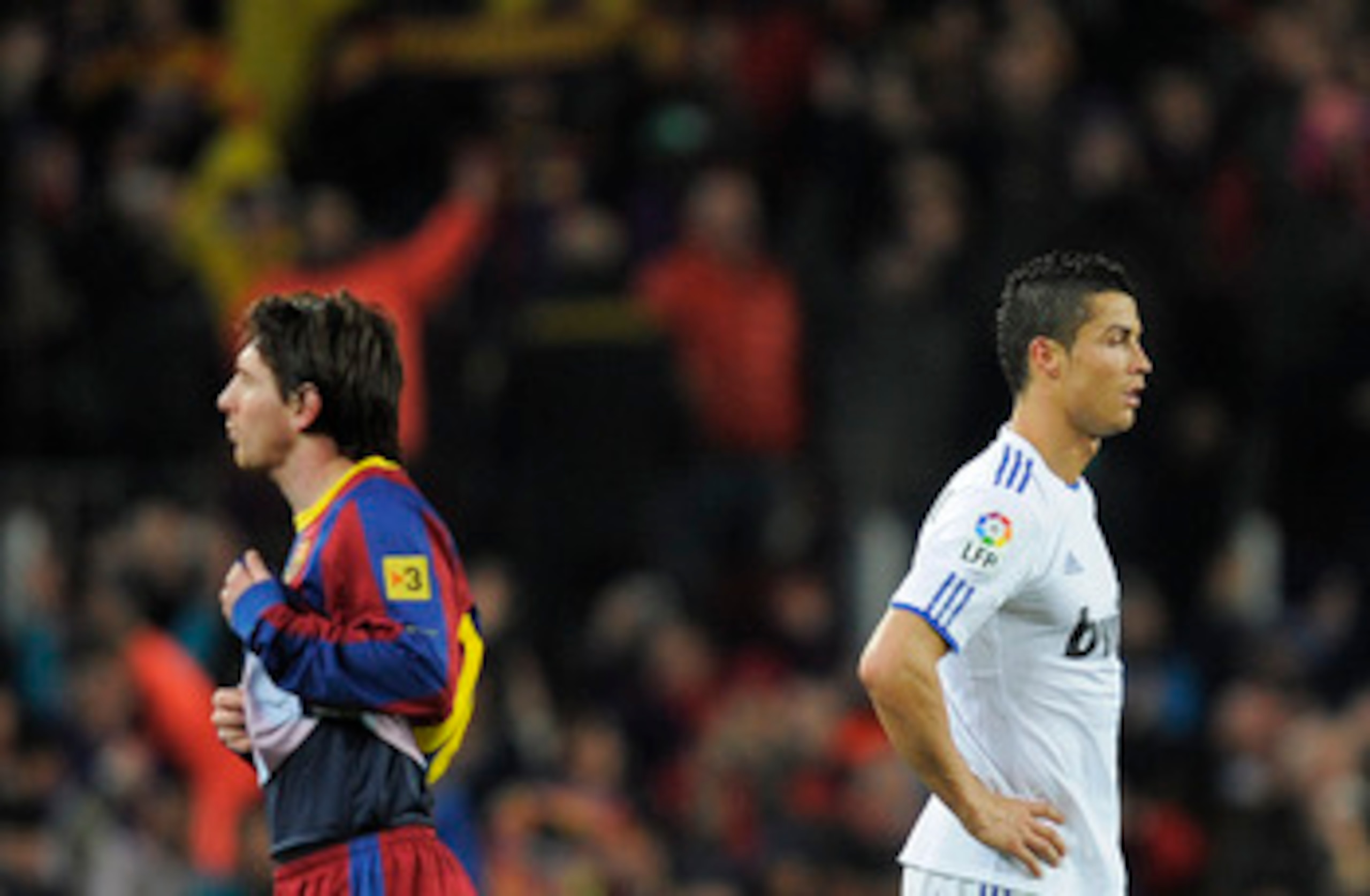 BARCELONA, SPAIN - NOVEMBER 29:  Cristiano Ronaldo of Real Madrid (R) and Lionel Messi of FC Barcelona look on during the La Liga match between Barcelona and Real Madrid at the Camp Nou Stadium on November 29, 2010 in Barcelona, Spain.  Barcelona won the