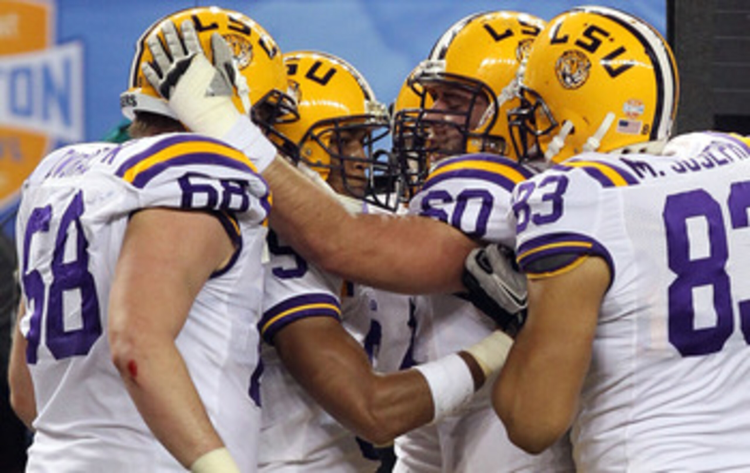 ARLINGTON, TX - JANUARY 07:  (L-R) Josh Dworaczyk #68, Jordan Jefferson #9, Will Blackwell #60 and Mitch Joseph #83 of the LSU Tigers celebrate a touchdown against the Texas A&M Aggies during the AT&T Cotton Bowl at Cowboys Stadium on January 7, 2011 in A