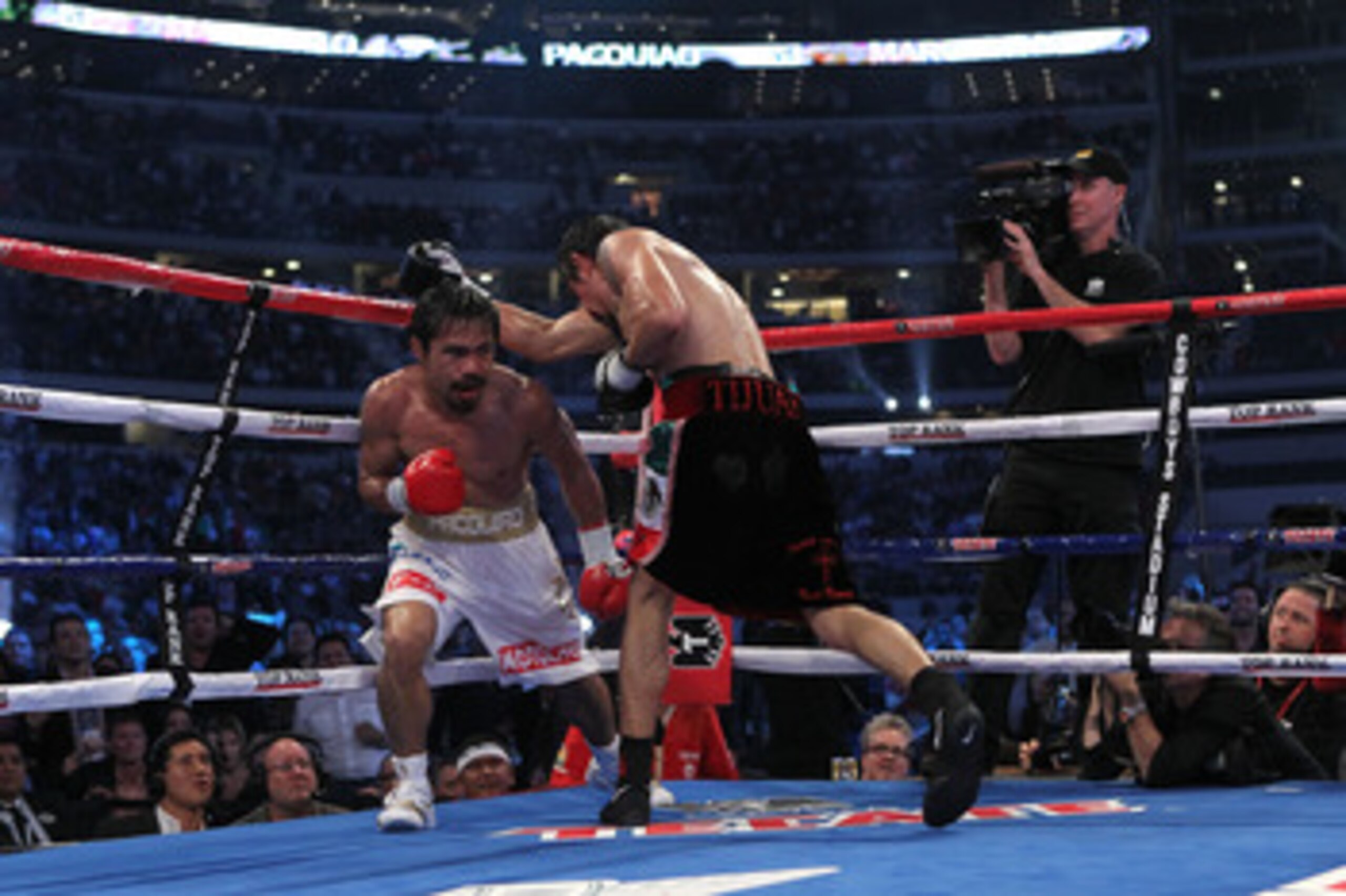 ARLINGTON, TX - NOVEMBER 13:  Manny Pacquiao (white trunks) of the Philippines fights against Antonio Margarito (black trunks) of Mexico during their WBC World Super Welterweight Title bout at Cowboys Stadium on November 13, 2010 in Arlington, Texas.  (Ph