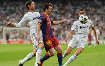 MADRID, SPAIN - APRIL 27:  Lionel Messi (C) of Barcelona duels for the ball with Sergio Ramos (L) and Alvaro Arbeloa of Real Madrid during the UEFA Champions League Semi Final first leg match between Real Madrid and Barcelona at the Estadio Santiago Berna
