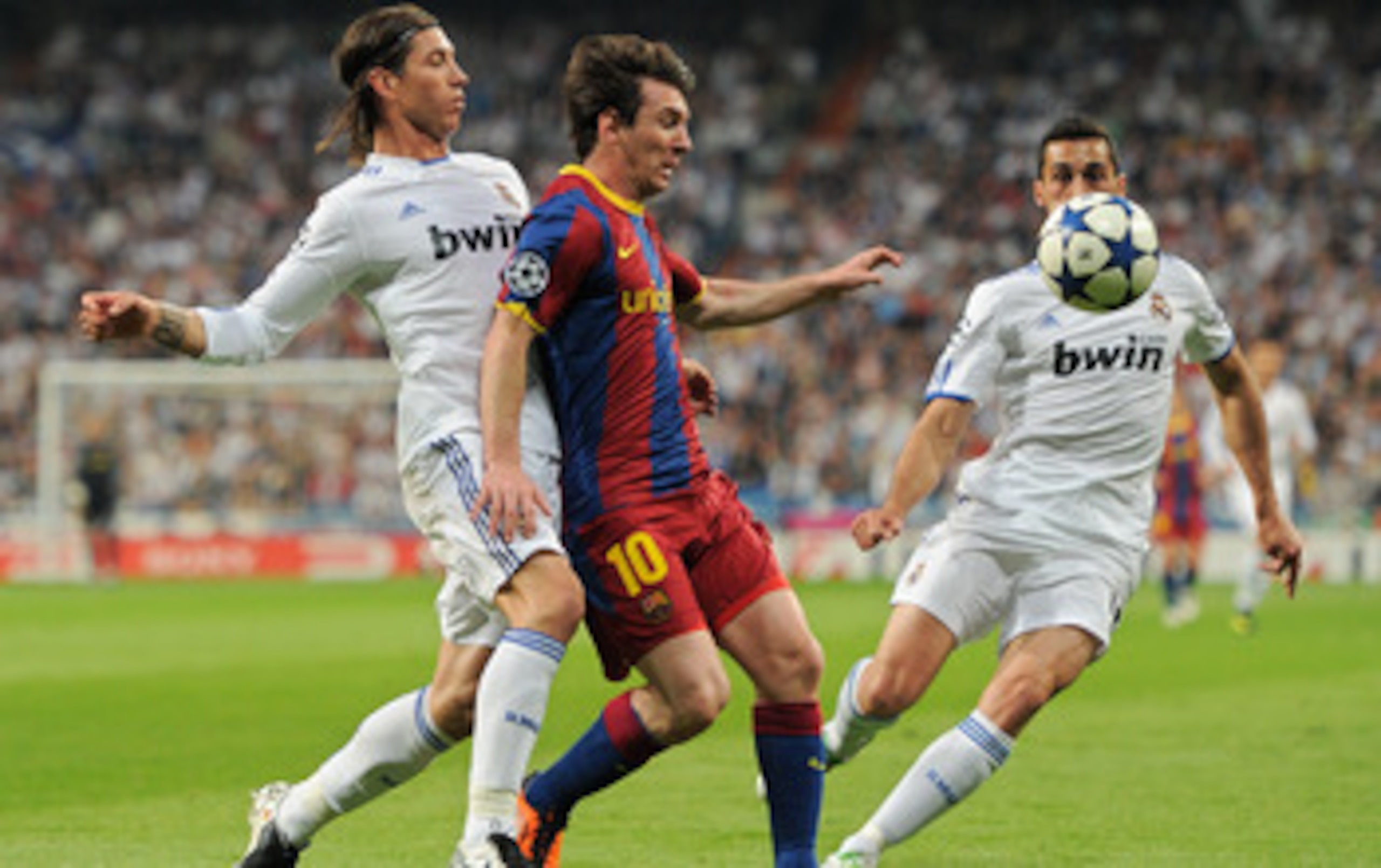 MADRID, SPAIN - APRIL 27:  Lionel Messi (C) of Barcelona duels for the ball with Sergio Ramos (L) and Alvaro Arbeloa of Real Madrid during the UEFA Champions League Semi Final first leg match between Real Madrid and Barcelona at the Estadio Santiago Berna