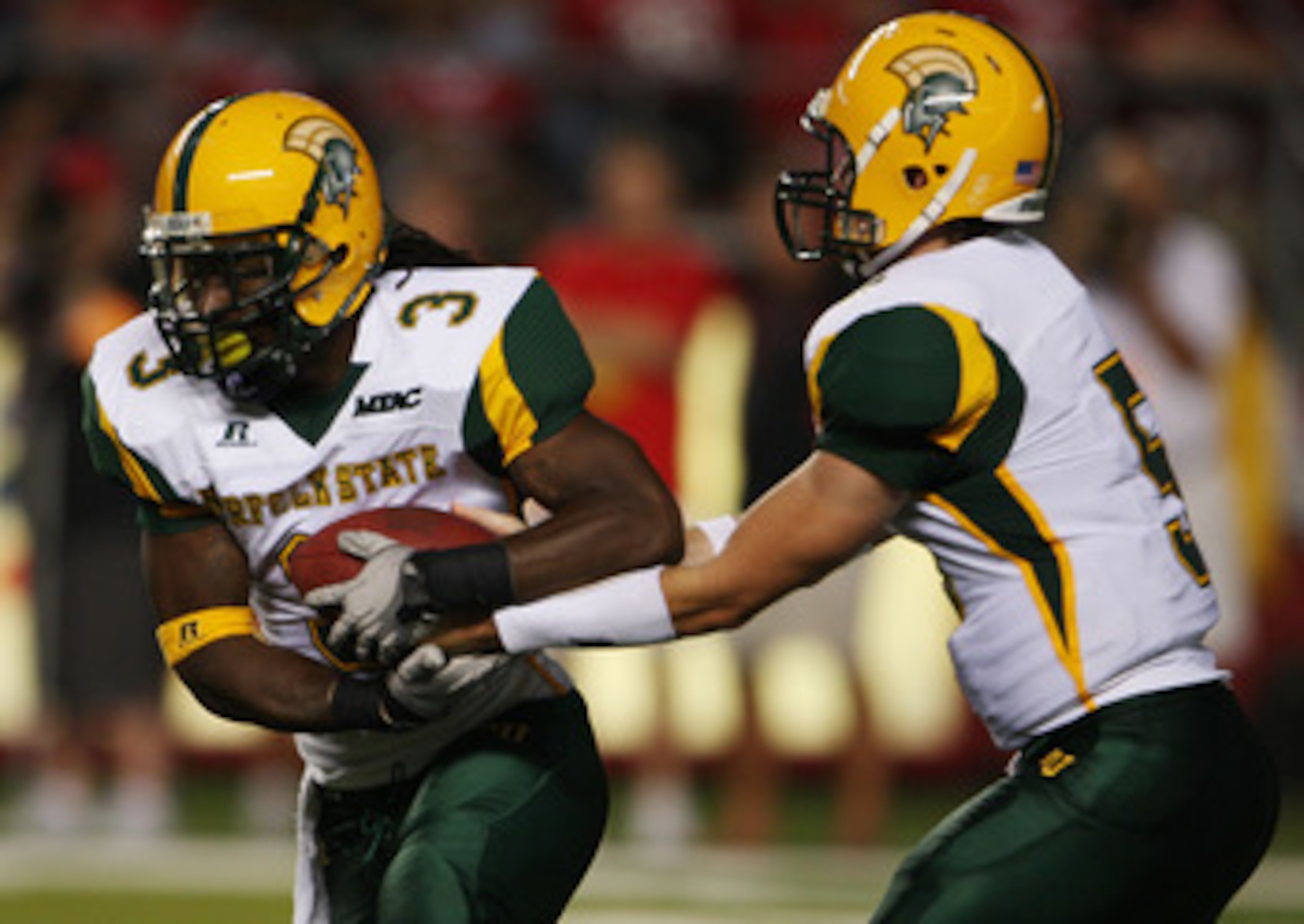 NEW BRUNSWICK, NJ - SEPTEMBER 02:  Chris Walley #5 of the Norfolk State Spartans hands the ball off to DeAngelo Branche #3 while playing against Rutgers' Scarlet Knights at Rutgers Stadium on September 2, 2010 in New Brunswick, New Jersey.  The Scarlet Kn