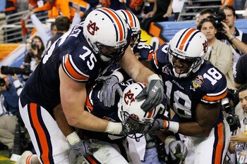 GLENDALE, AZ - JANUARY 10:  (C) Michael Dyer #5 of the Auburn Tigers celebrates with teammates Brandon Mosley #75 and Kodi Burns #18 after he ran the ball for 16-yards and is called down at the one-yardline with 10 seconds remaining in the fourth quarter 