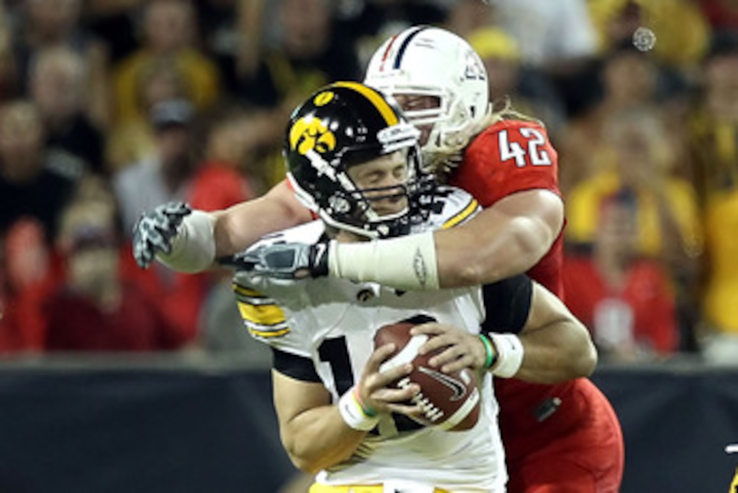 TUCSON, AZ - SEPTEMBER 18: Quarterback Ricky Stanzi #12 of the Iowa Hawkeyes is sacked by Brooks Reed #42 of the Arizona Wildcats during the third quarter of the college football game at Arizona Stadium on September 18, 2010 in Tucson, Arizona. The Wild TUCSON, AZ - SEPTEMBER 18: Quarterback Ricky Stanzi #12 of the Iowa Hawkeyes is sacked by Brooks Reed #42 of the Arizona Wildcats during the third quarter of the college football game at Arizona Stadium on September 18, 2010 in Tucson, Arizona. The Wild