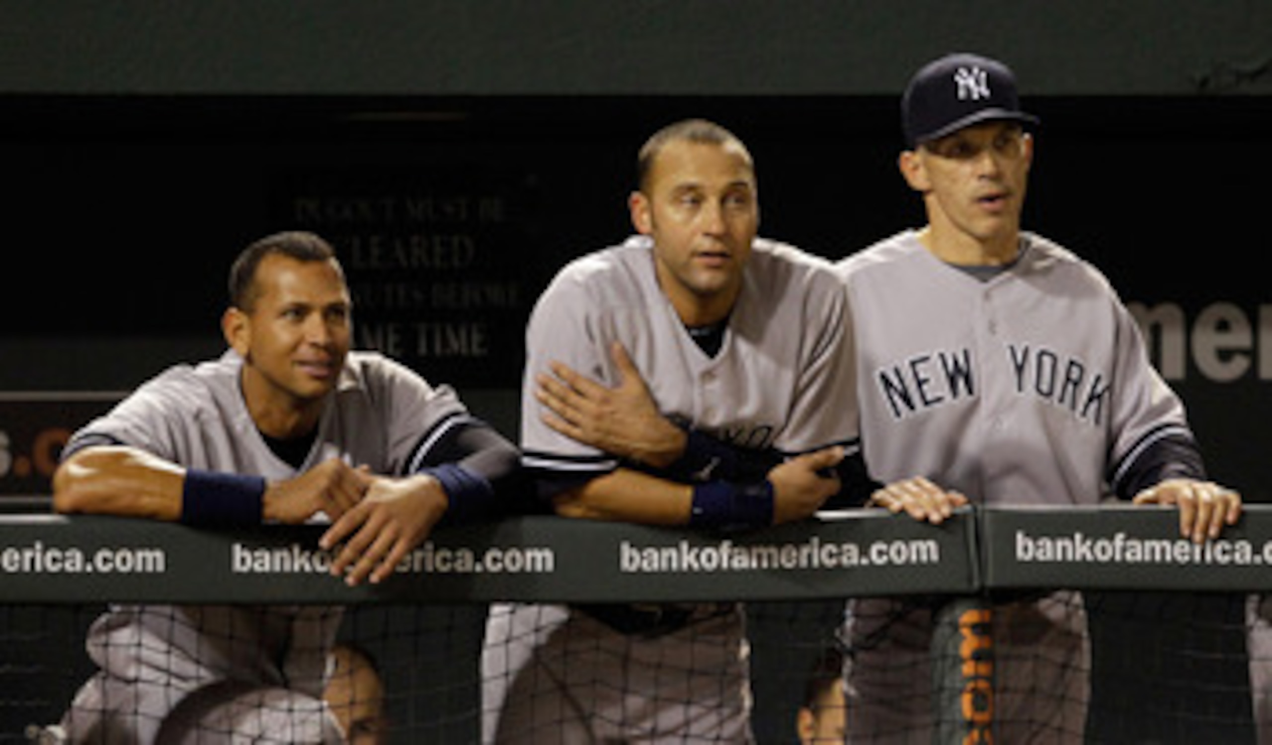 BALTIMORE, MD - APRIL 23:  Alex Rodriguez #13 of the New York Yankees (L) Derek Jeter #2 (C) and manager Joe Girardi #28 (R) look out from the dugout during the eighth inning of their 15-3 win over the Baltimore Orioles at Oriole Park at Camden Yards on A