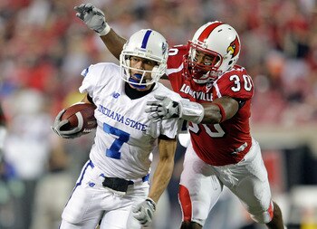 LOUISVILLE, KY - SEPTEMBER 05:  Daniel Covington #30 of the Louisville Cardinals tackles Larry Lacotti #7 of the Indiana State Sycamores during the game at Papa John's Cardinal Stadium on September 5, 2009 in Louisville, Kentucky.  (Photo by Andy Lyons/Ge