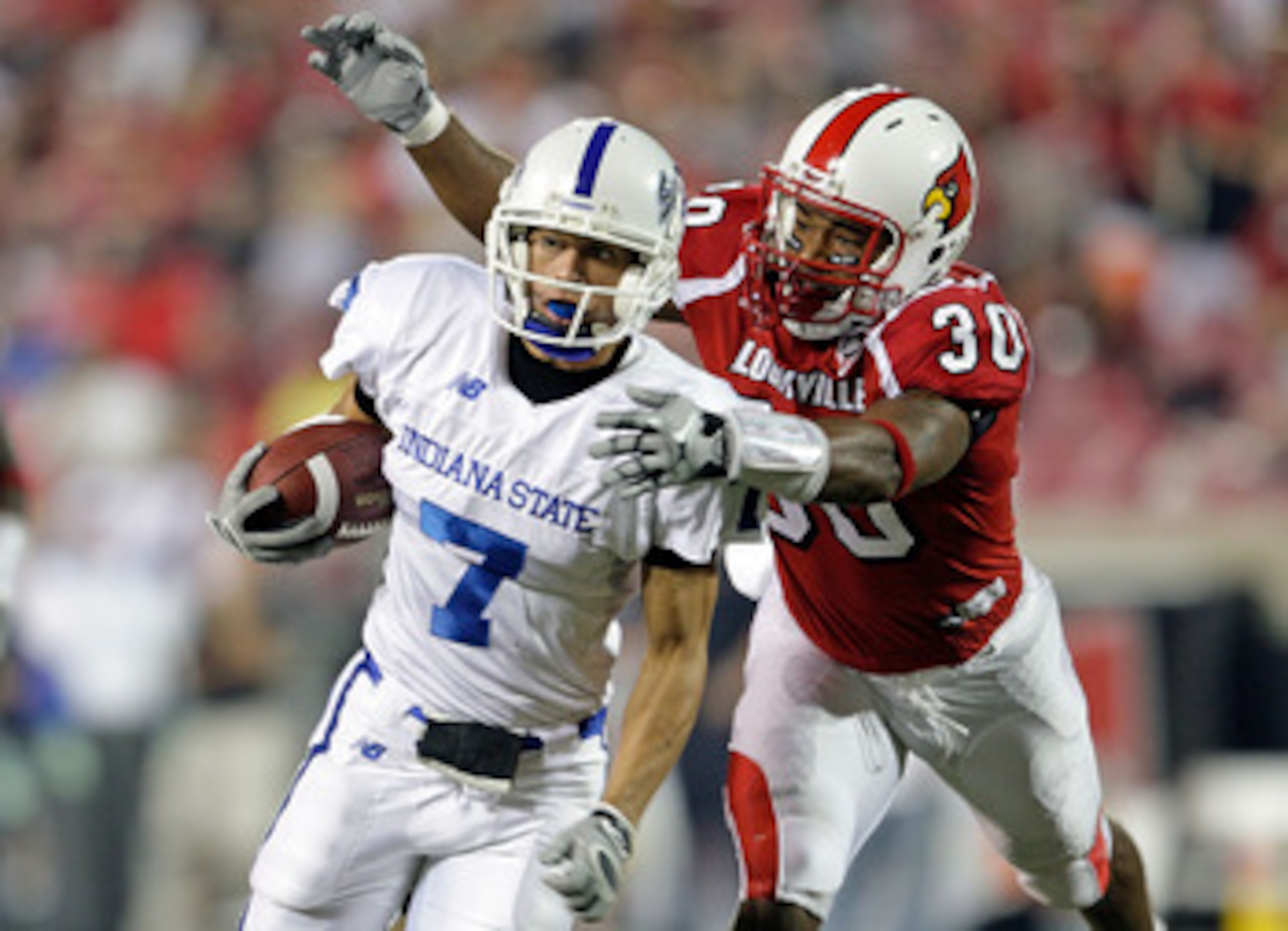 LOUISVILLE, KY - SEPTEMBER 05:  Daniel Covington #30 of the Louisville Cardinals tackles Larry Lacotti #7 of the Indiana State Sycamores during the game at Papa John's Cardinal Stadium on September 5, 2009 in Louisville, Kentucky.  (Photo by Andy Lyons/Ge