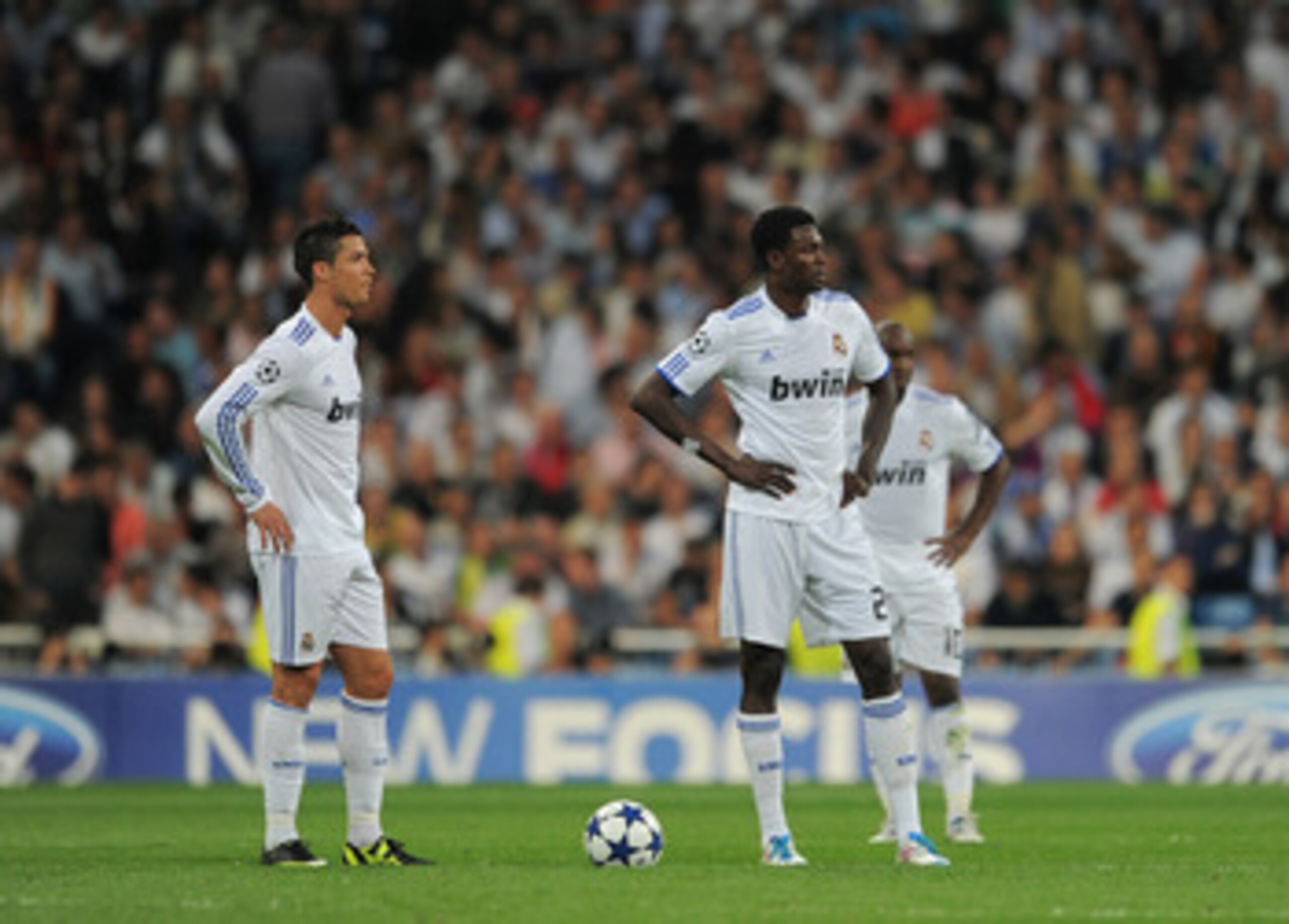 MADRID, SPAIN - APRIL 27:  Emmanuel Adebayor (R) of Real Madrid stands dejected with his teammates Cristiano Ronaldo (L) and Lassana Diarra after conceding a goal during the UEFA Champions League Semi Final first leg match between Real Madrid and Barcelon