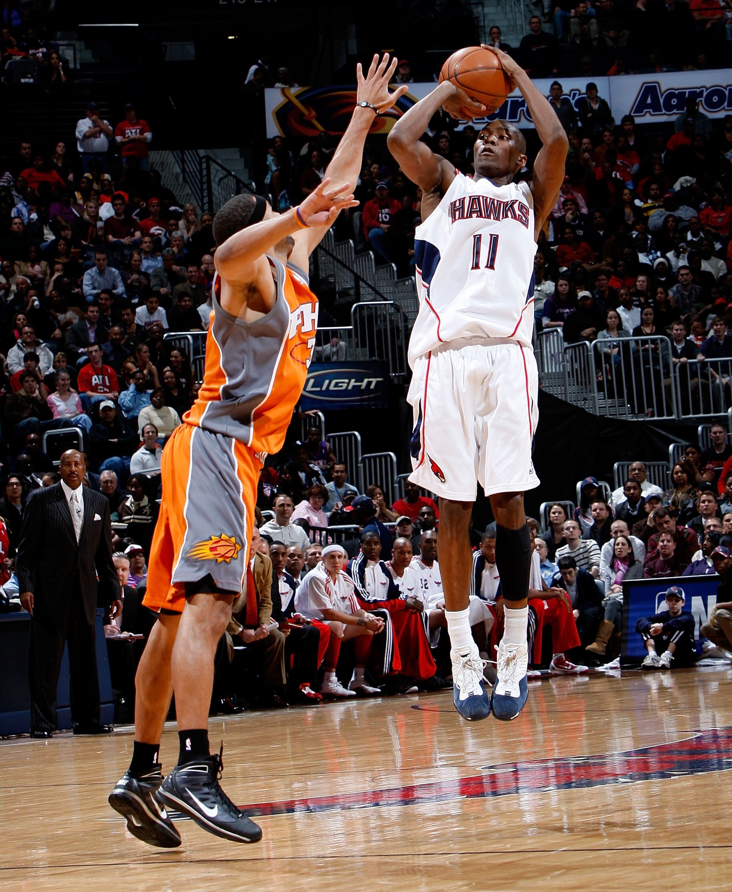 ATLANTA - JANUARY 15:  Jamal Crawford #11 of the Atlanta Hawks against Jared Dudley #3 of the Phoenix Suns at Philips Arena on January 15, 2010 in Atlanta, Georgia.  NOTE TO USER: User expressly acknowledges and agrees that, by downloading and/or using th