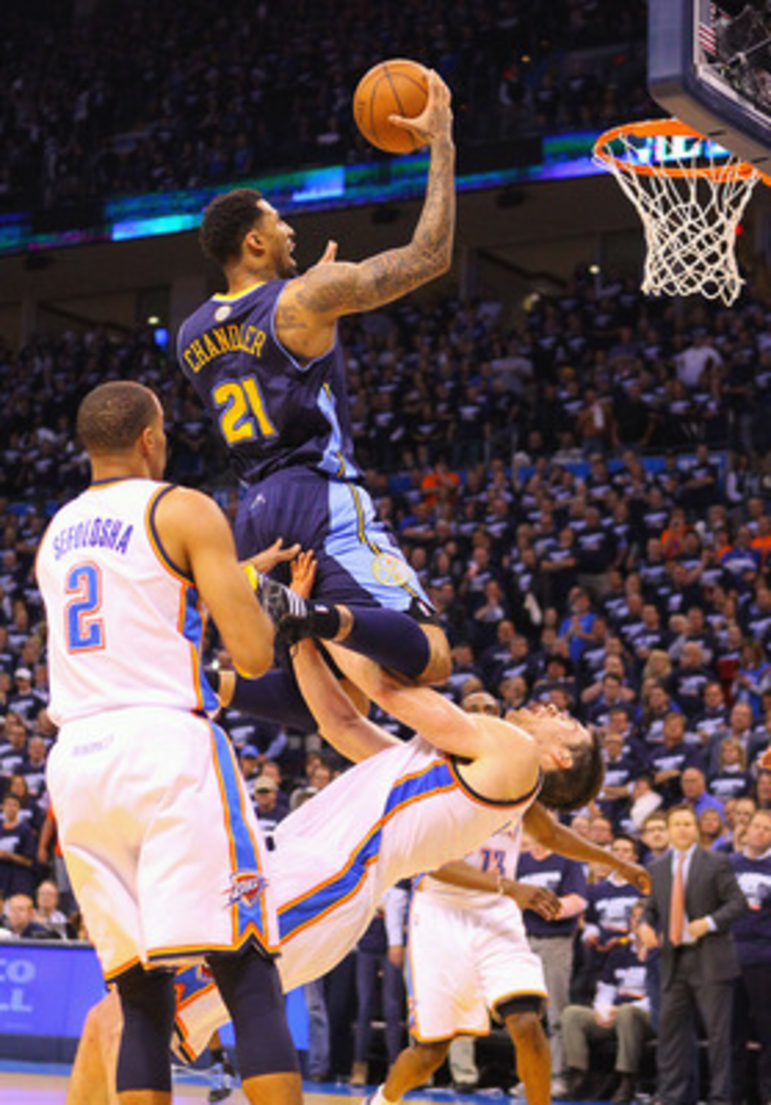 OKLAHOMA CITY, OK - APRIL 27: Wilson Chandler #21 of the Denver Nuggets drives to the basket against Nick Collison #4 of the Oklahoma City Thunder in Game Five of the Western Conference Quarterfinals in the 2011 NBA Playoffs on April 27, 2011 at the Ford 