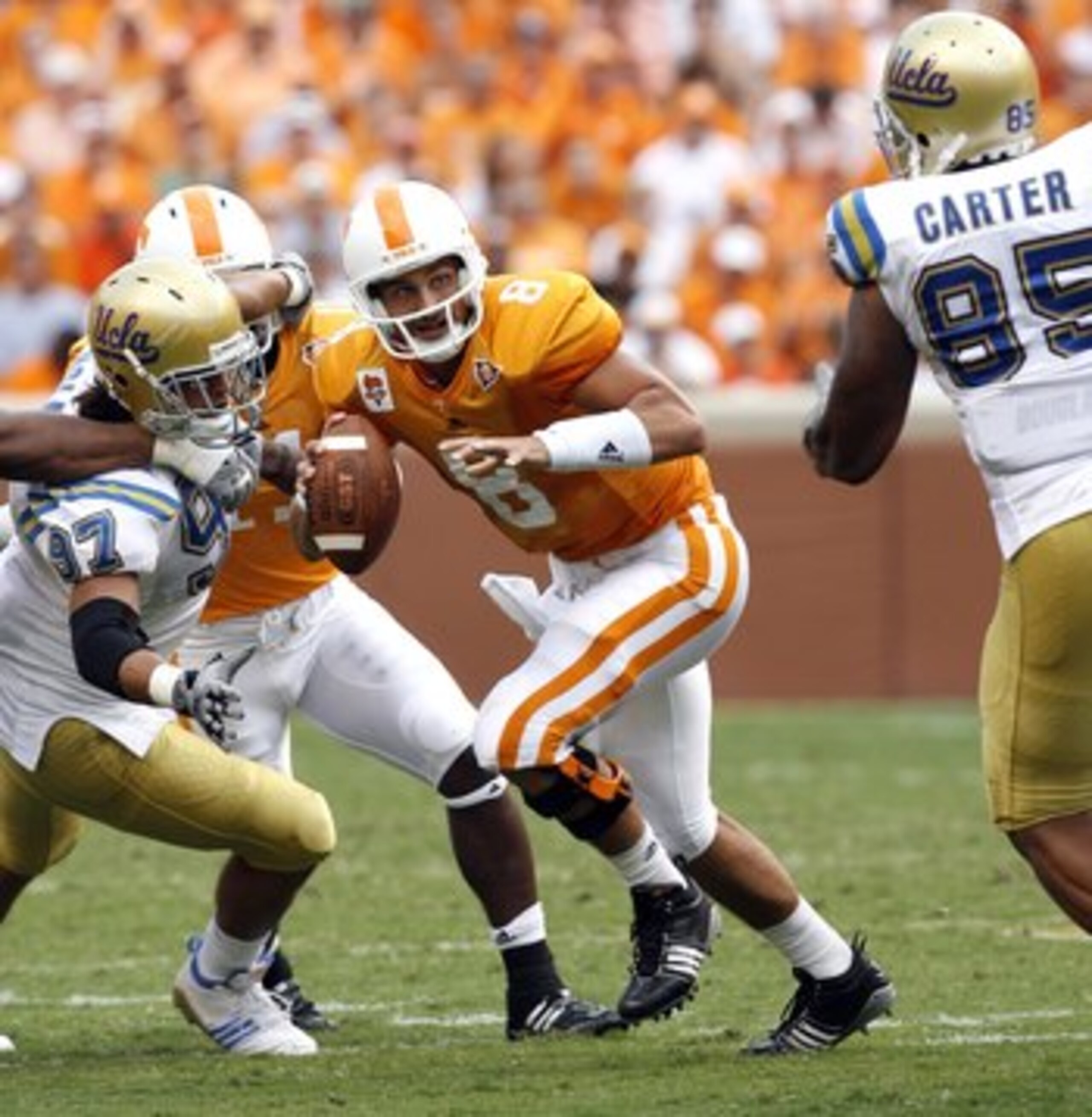 KNOXVILLE, TN - SEPTEMBER 12: Jonathan Crompton #8 of the Tennessee Volunteers scrambles against David Carter #85 of the UCLA Bruins on September 12, 2009 at Neyland Stadium in Knoxville, Tennessee. UCLA beat Tennessee 19-15. (Photo by Joe Murphy/Getty Im