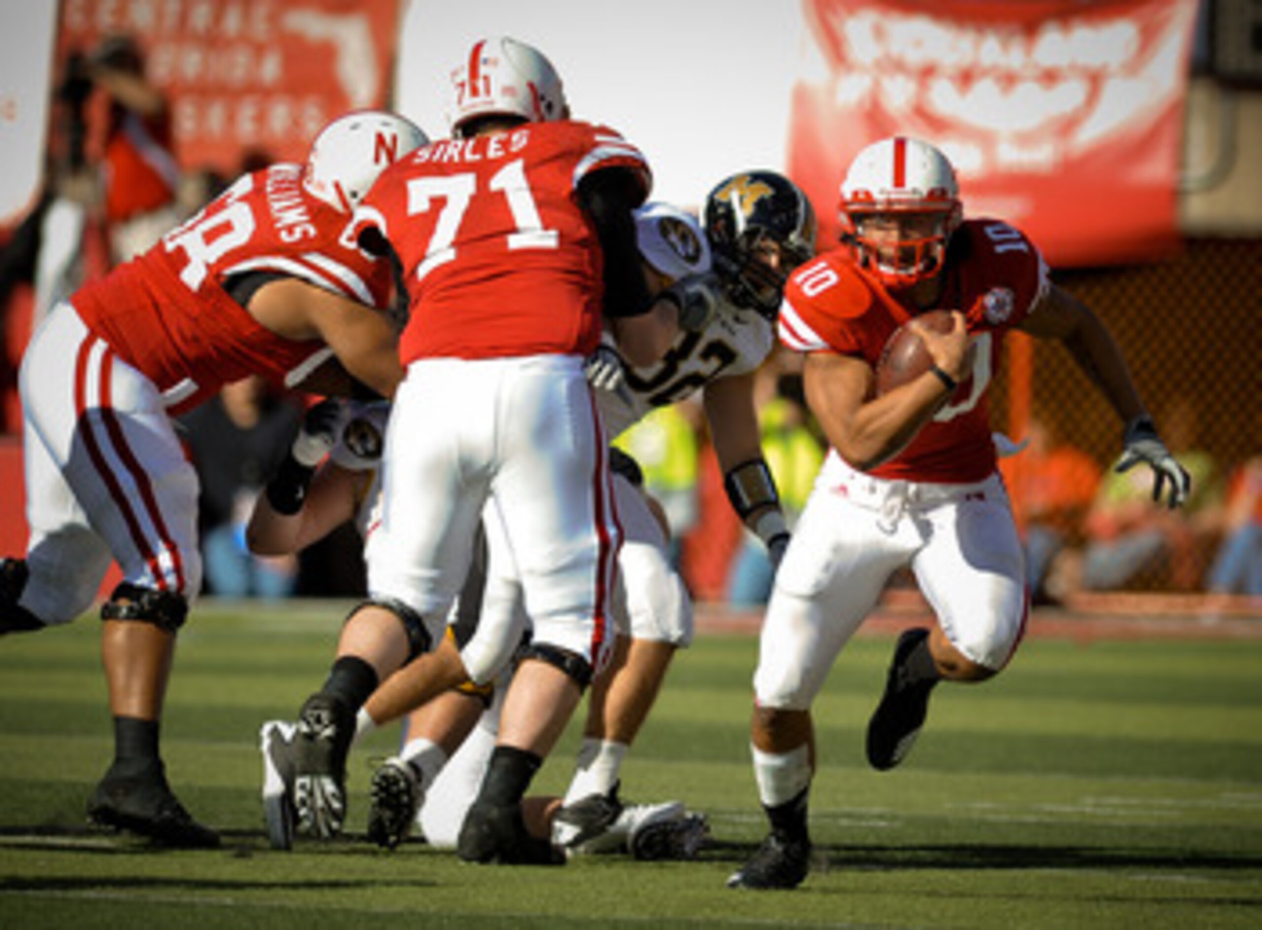 LINCOLN, NE - OCTOBER 30: Running back Roy Helu Jr. #10 of the Nebraska Cornhuskers , with the help of teammates  offensive linesman Jeremiah Sirles #71 and  offensive linesman Keith Williams #68 break a long run against the Missouri Tigers during second 