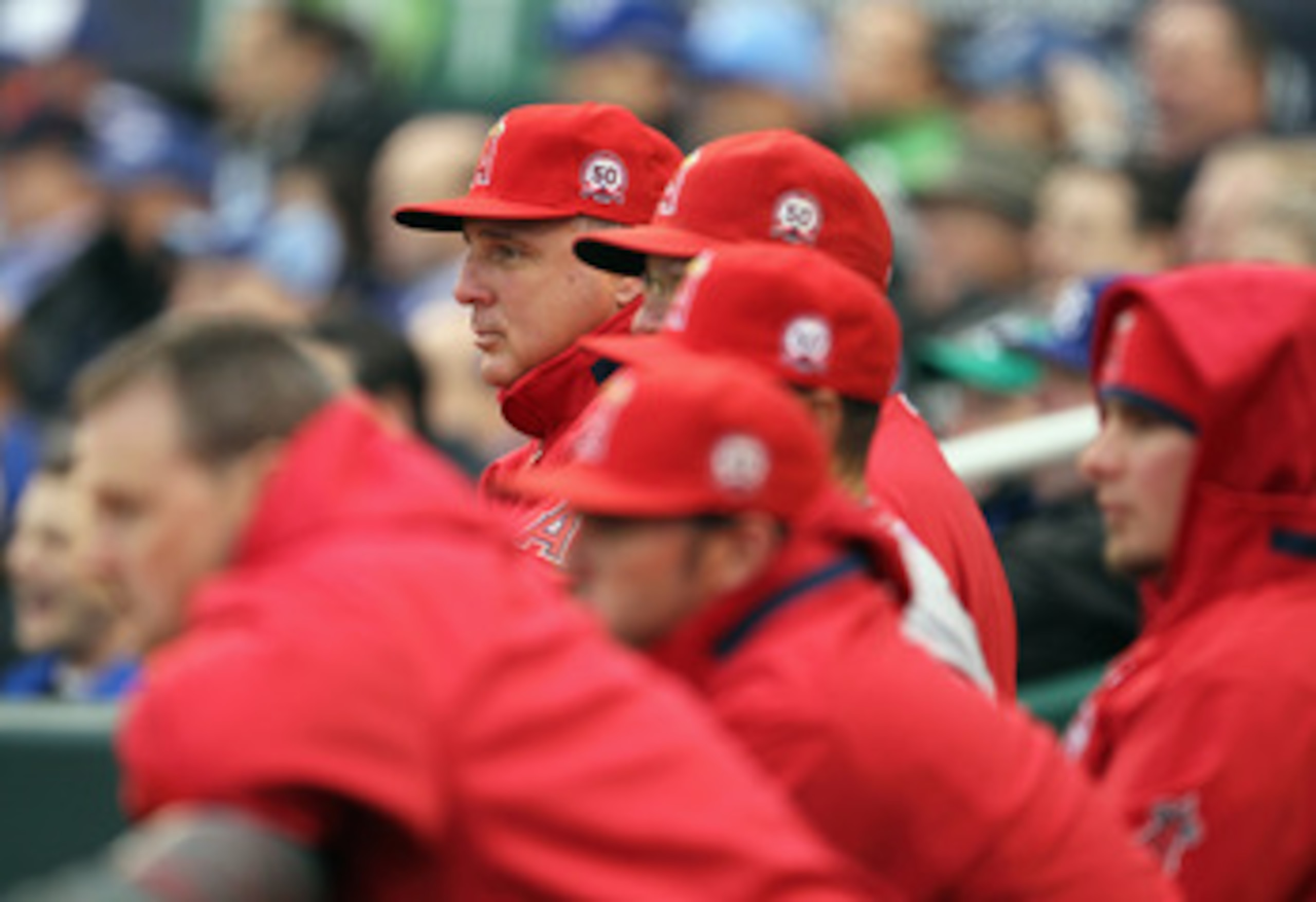 KANSAS CITY, MO - MARCH 31:  Manager Mike Scioscia #14 of the Los Angeles Angels of Anaheim watches from the dugout during the opening day game against the Kansas City Royals at Kauffman Stadium on March 31, 2011 in Kansas City, Missouri.  (Photo by Jamie