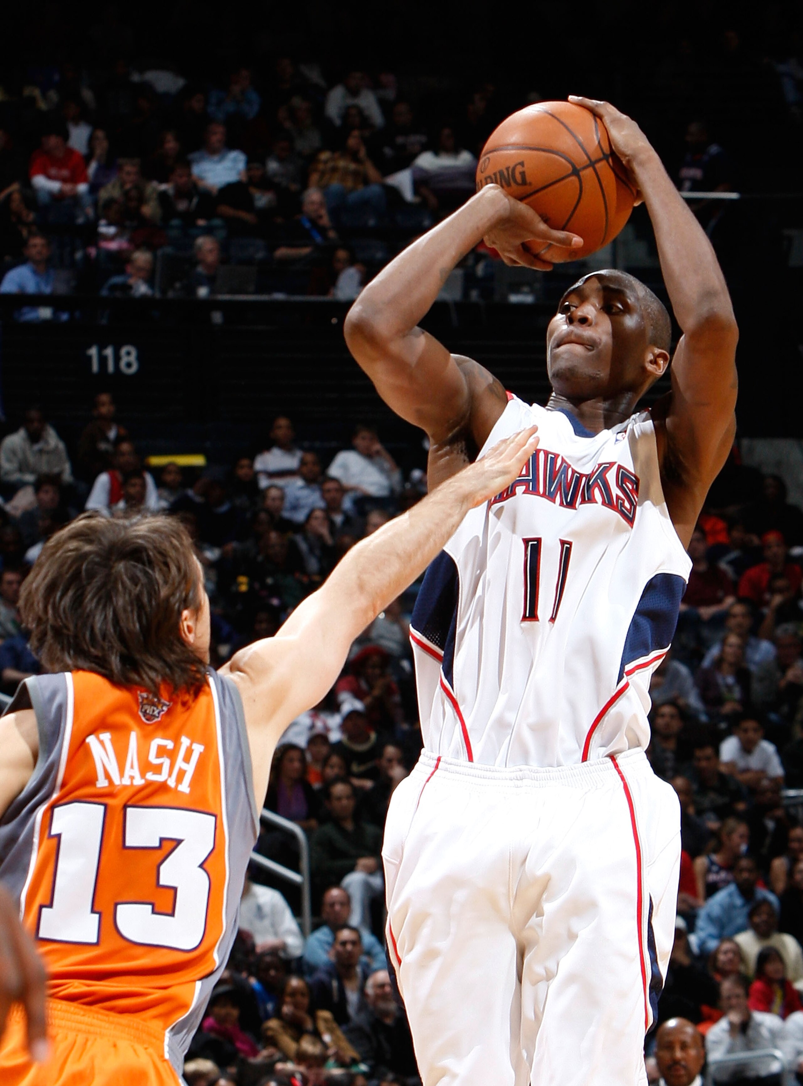ATLANTA - JANUARY 15:  Jamal Crawford #11 of the Atlanta Hawks shoots over Steve Nash #13 of the Phoenix Suns at Philips Arena on January 15, 2010 in Atlanta, Georgia.  NOTE TO USER: User expressly acknowledges and agrees that, by downloading and/or using